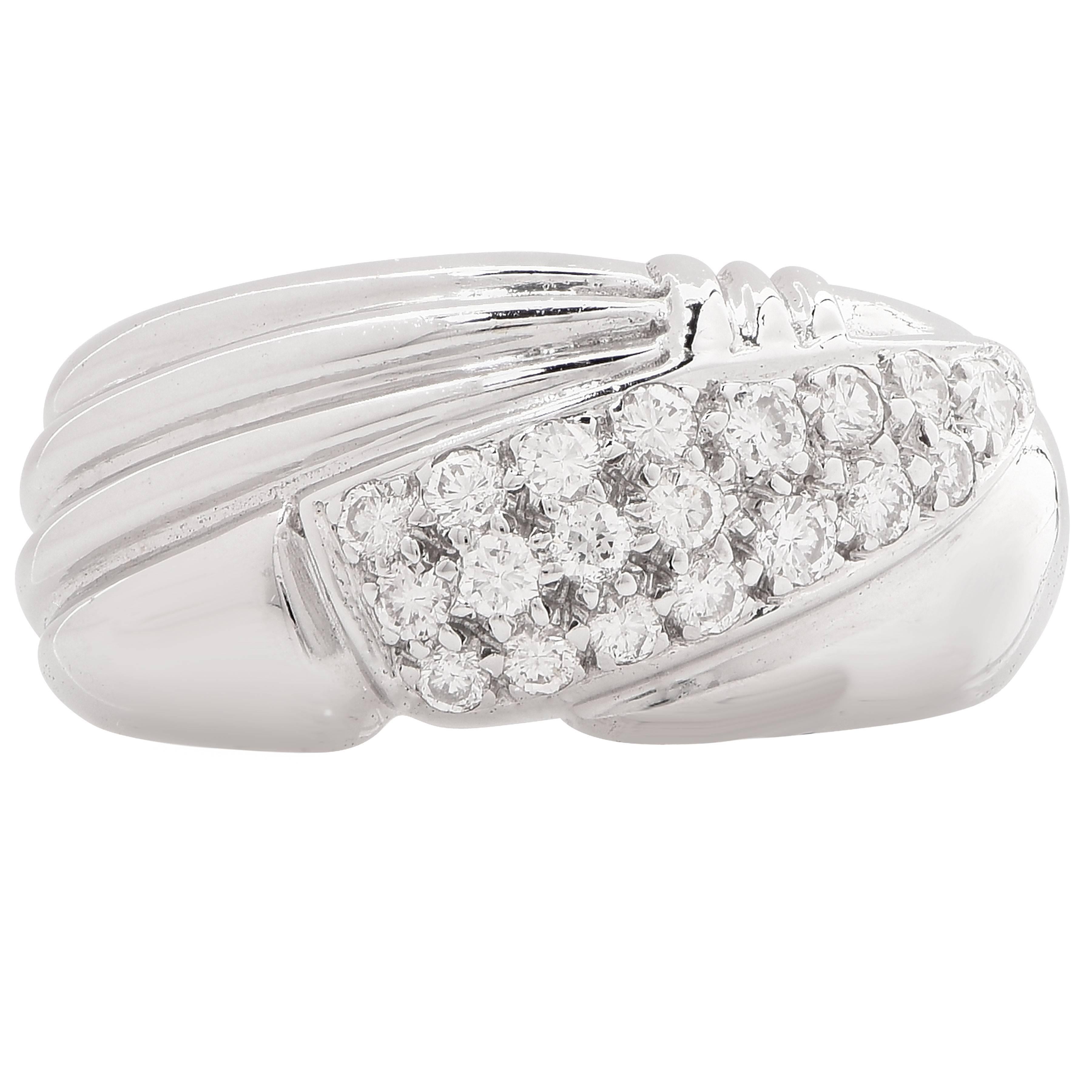 18 Karat White Gold Ring with Diamonds. This modern design ring features 20 round brilliant cut diamonds with an estimated total weight of .40 carat.

Metal: 18 Kt. White Gold (stamped and/or tested)
Metal Weight: 7.46 Grams
Ring Size: 6 3/4 (can be
