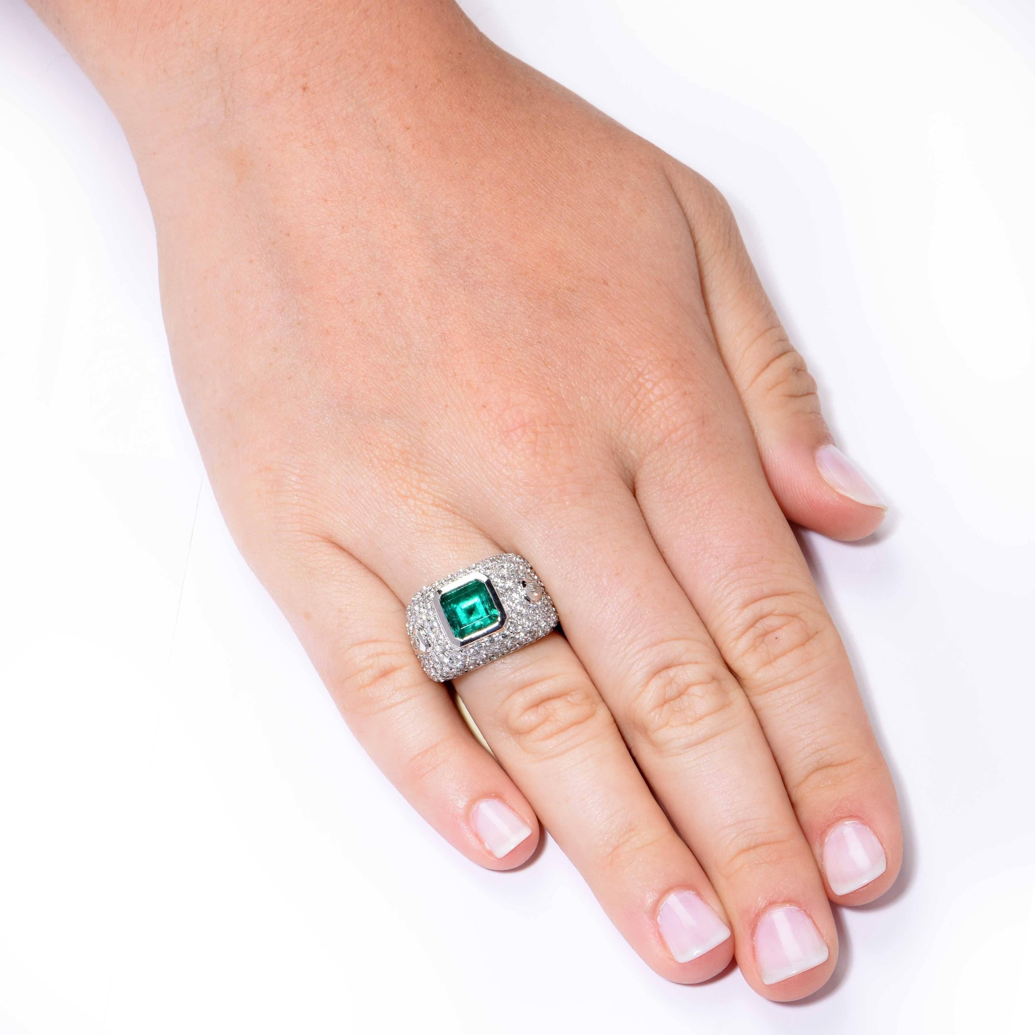 This beautiful emerald and diamond ring features a 3.10 Carat Natural Emerald surrounded by approximately 4.10cts of round brilliant cut diamonds set in 18 Karat White Gold.

Ring Size: 7 1/4 (can be sized)
Metal: 18 Kt White Gold (stamped and/or