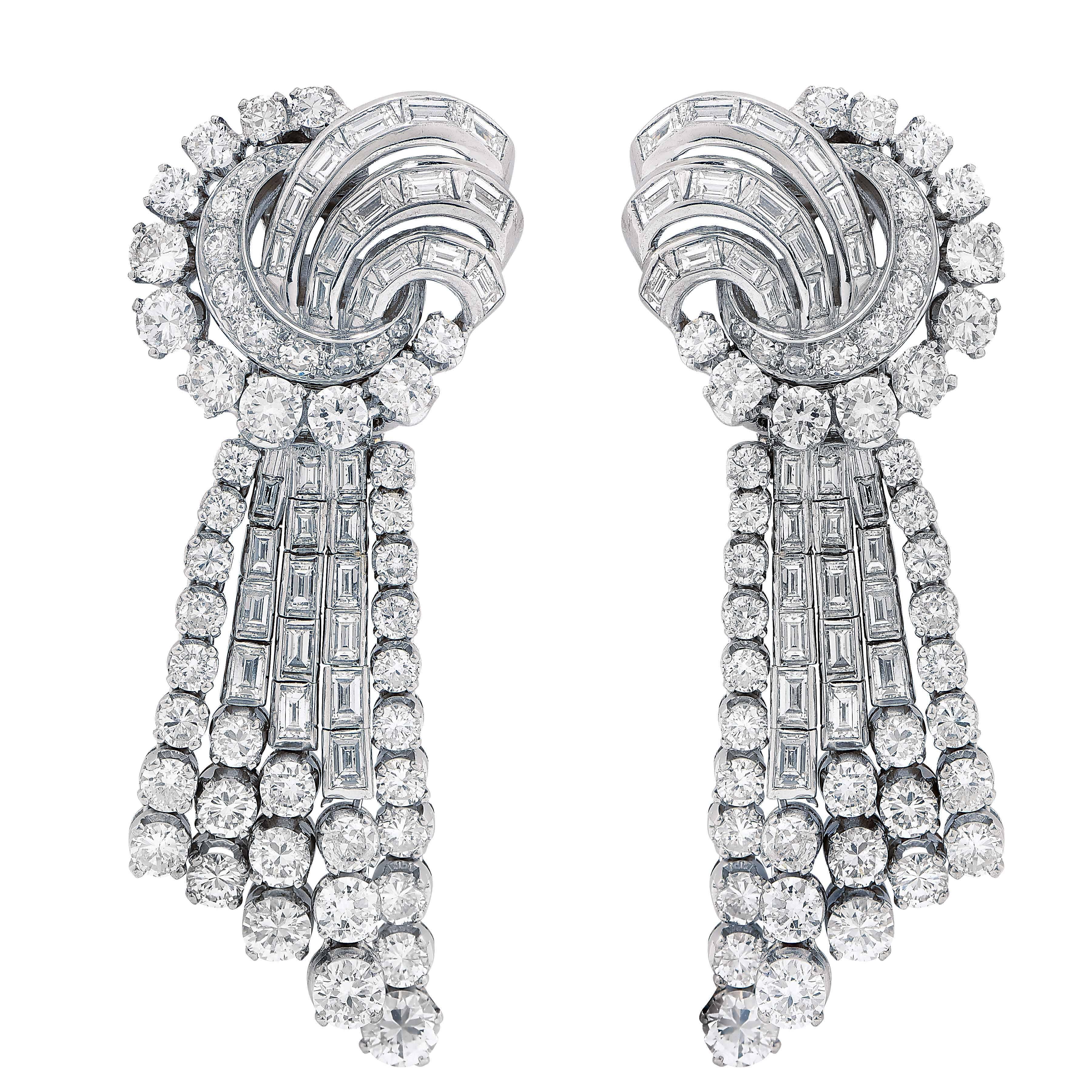 Pendant ear clips set with round and tapered baguette diamonds weighing approximately 12.12 carats, set in platinum. Detachable bottoms. 
Diamonds average G color VS2 clarity.

Metal Type: Platinum Stamped or Tested
Metal Weight: 45.8 grams