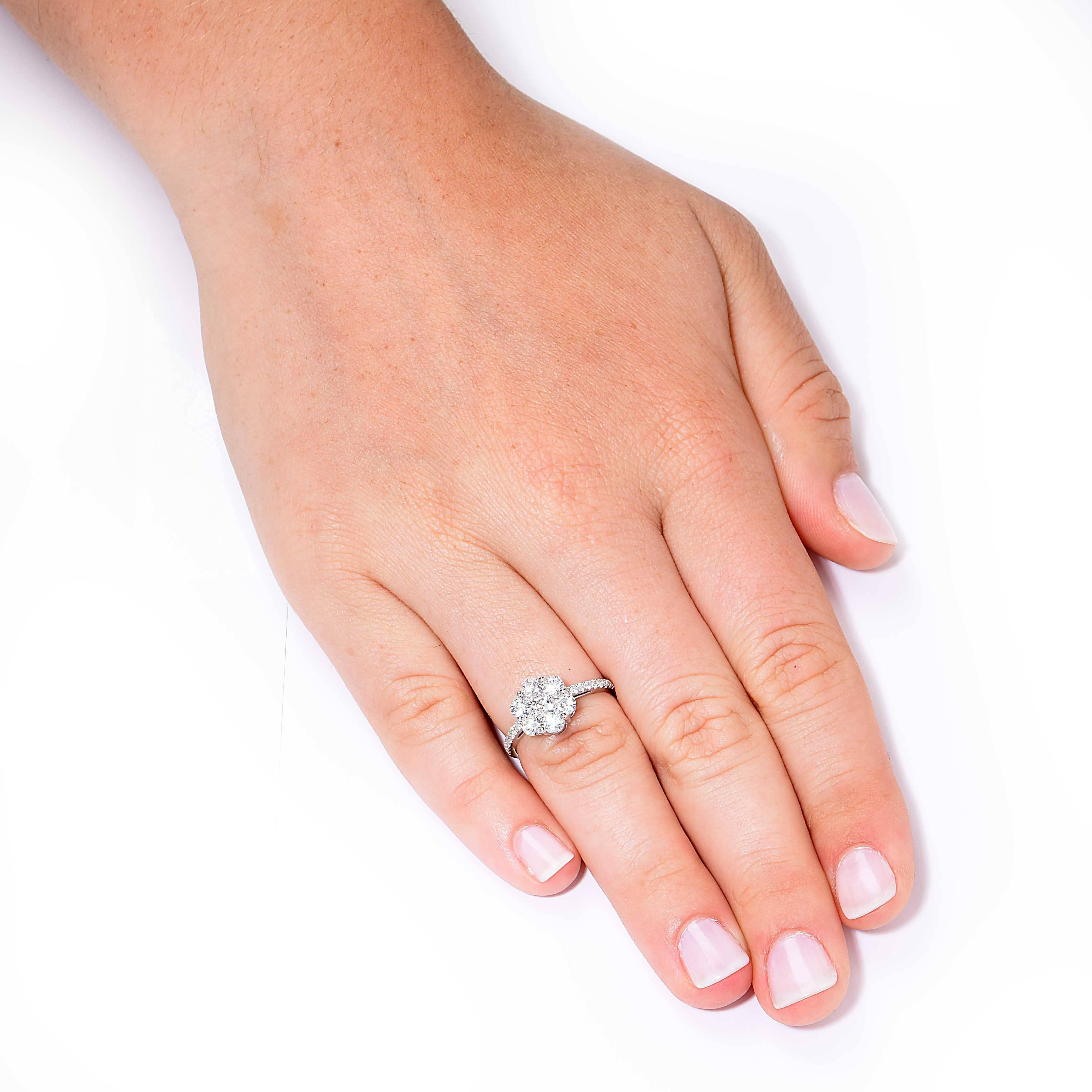 Diamond Flower Ring featuring 21 round brilliant cut diamonds with an estimated total weight of 1.3 carats set in 18 Kt. White Gold.

Ring Size: 6 1/2 (can be sized)
Metal Type: 18 Kt White Gold (stamped and/or tested)
Metal Weight: 3.3 Grams