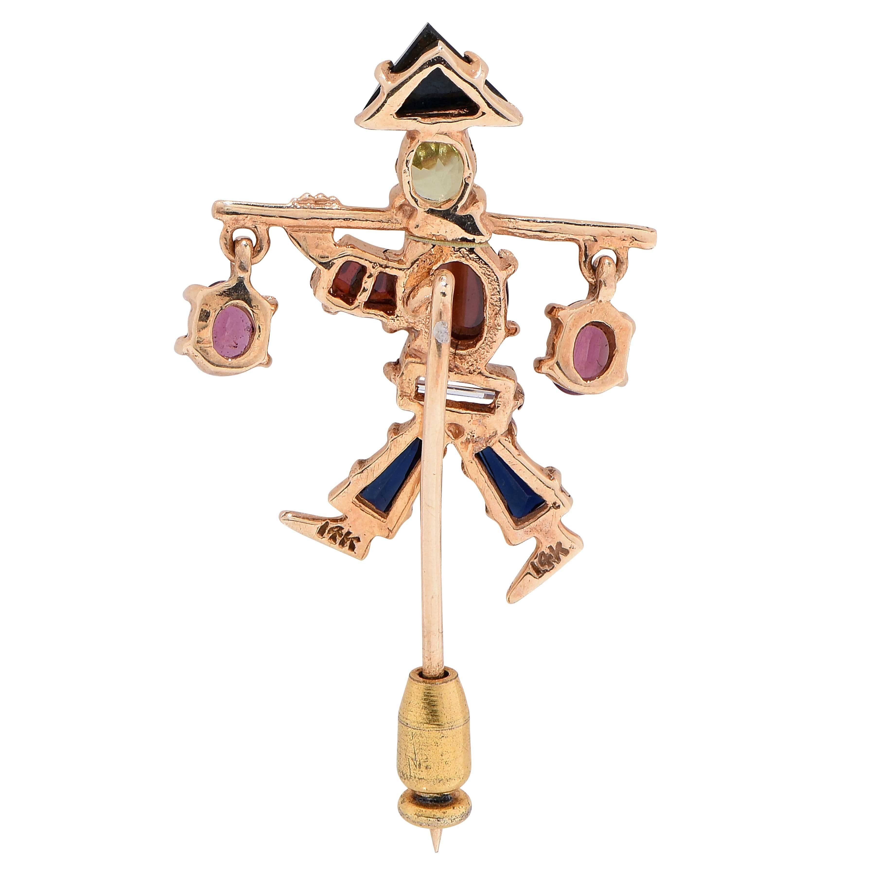 This unique happy water bearer brooch features 10 various gemstones set in 14 Kt Yellow Gold.
