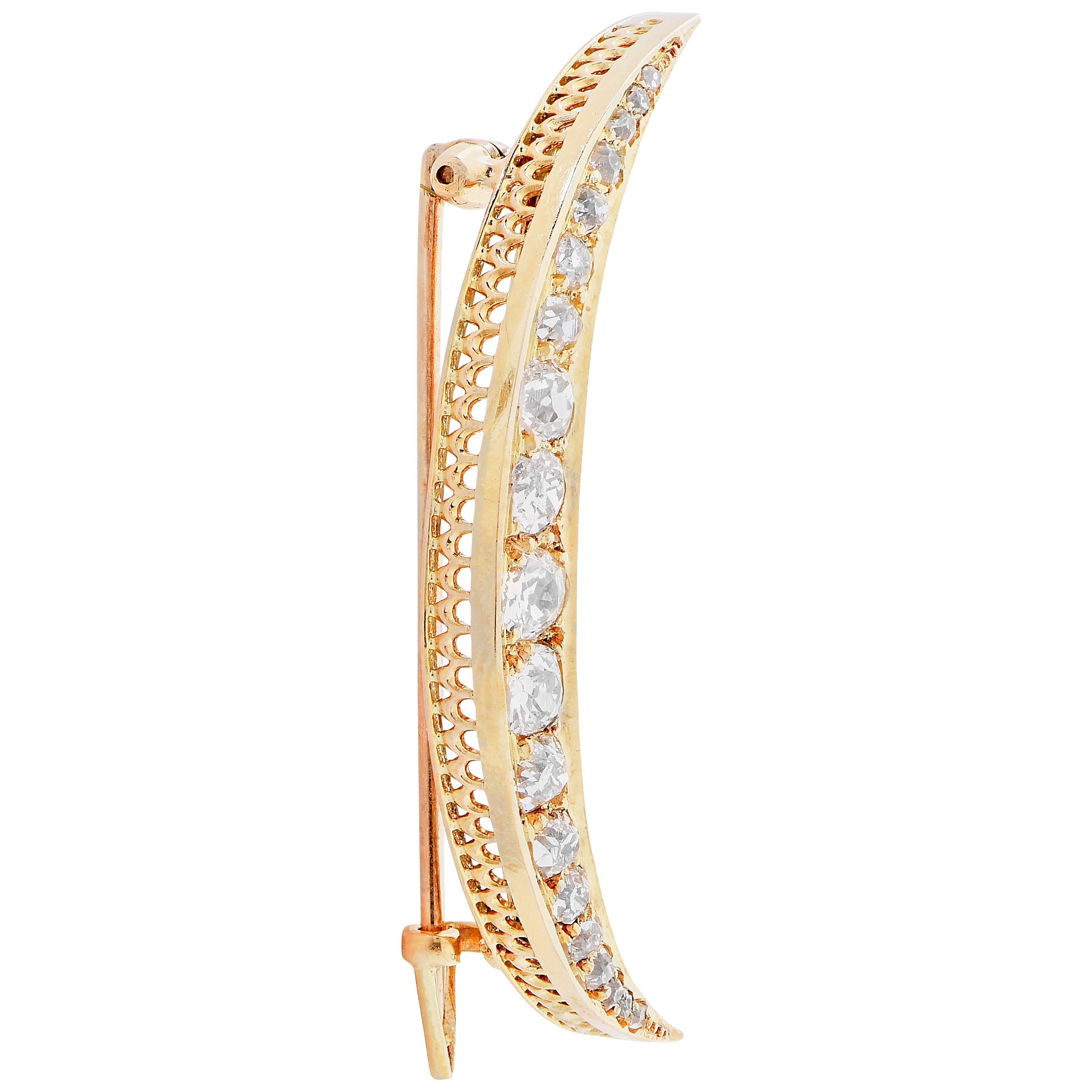 Antique Half moon brooch featuring 19 old mine cut diamonds with an estimated total weight of 1.25 carats set in 18 karat yellow gold.

Metal Type: 18 Kt Yellow Gold
Metal Weight: 5.3 Grams