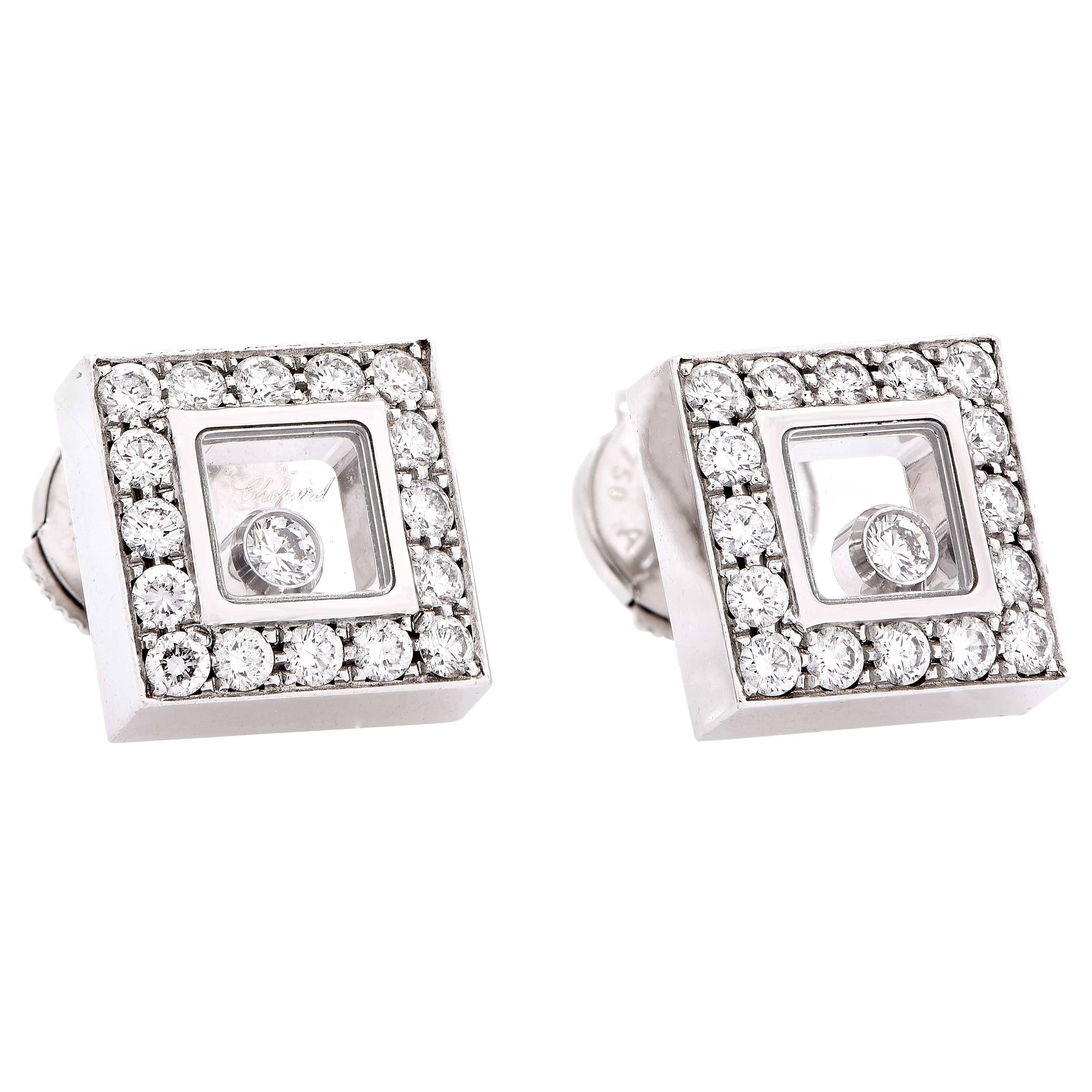 Marvelous 18kt white gold is crafted into squares that are embellished with striking white diamonds as a single floating diamond dances in the center of each stud earring. New in box with papers.
Chopard model 832896-1001
32 Pavee set diamonds with