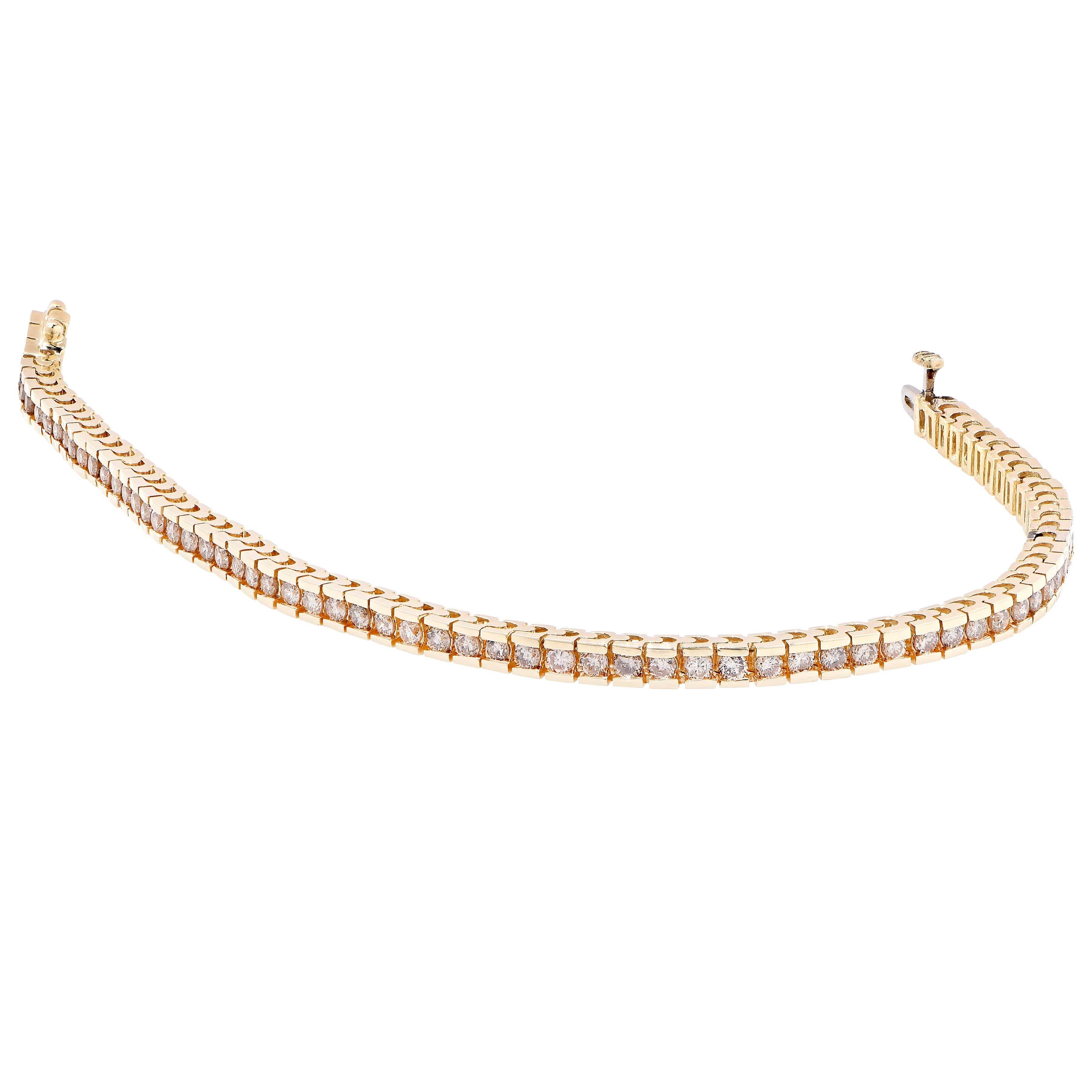 This modern design channel set diamond bracelet features 70 channel set round brilliant cut diamonds with an estimated total weight of 2.8 carats. 

Metal Type: 14 Kt Yellow Gold