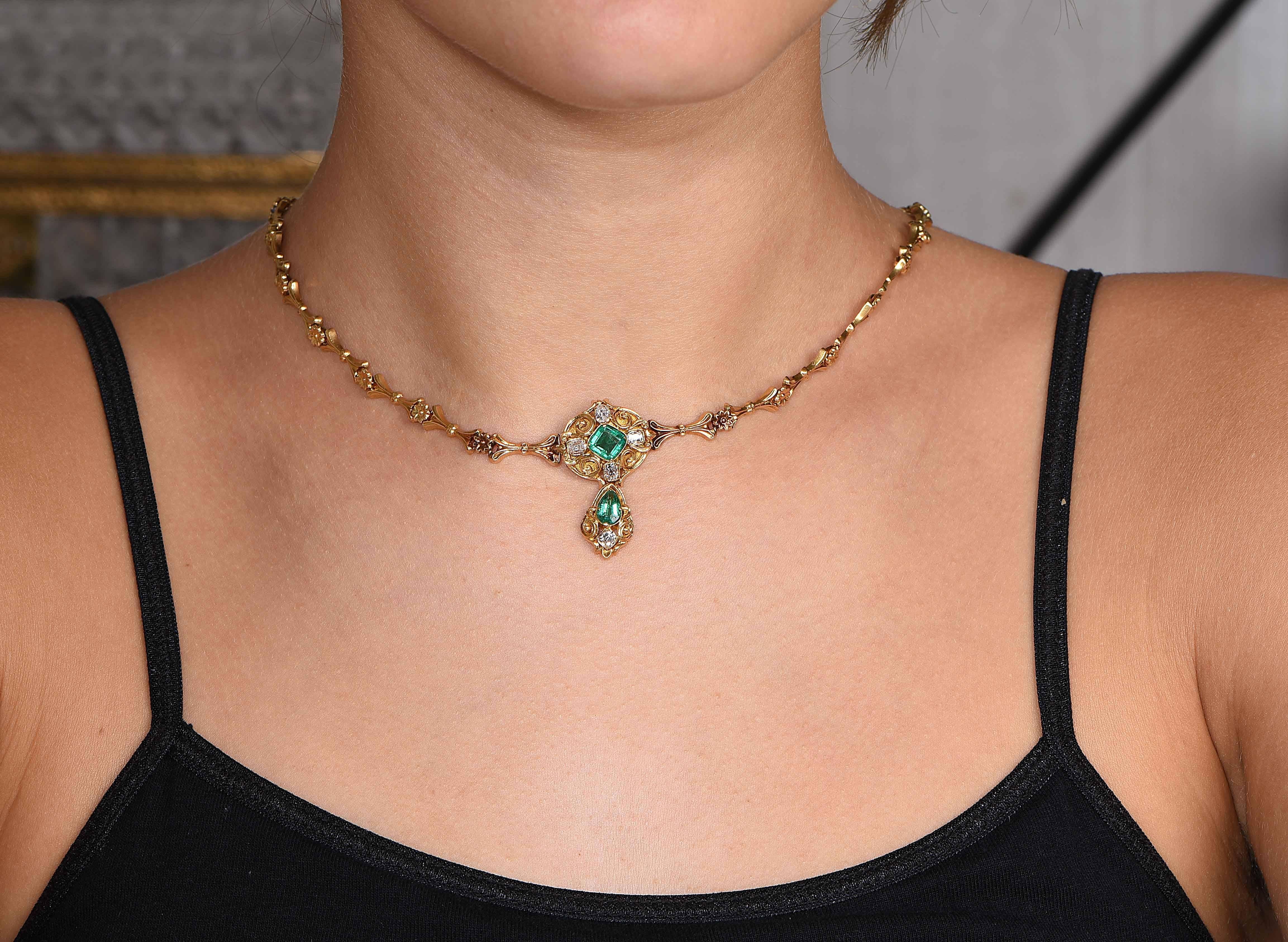 Antique gold, emerald and diamond necklace circa 1850. This necklace features One square step cut cushion cut emerald with an approximate weight of .65 carat; One step cut pear shaped emerald with an approximate weight of .40 carat; 5 cushion shaped