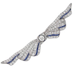 Vintage 3 Carat Diamond and Sapphire Ribbon Platinum Brooch. Circa 1930