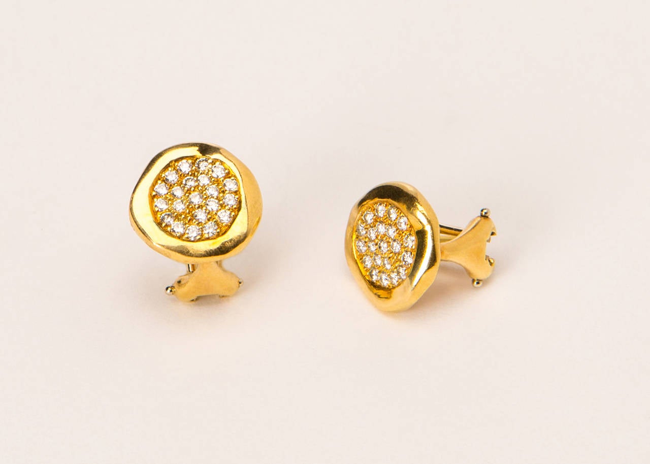 A soft gold edge frames brilliant cut diamonds. A great all the time diamond stud earring. Approximately 1/2 inch in size