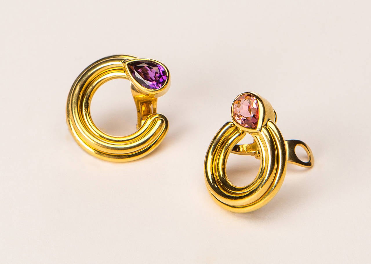 The simple elegance of Bvlgari makes an everyday earring exciting. Bezel set tourmaline and amethyst create a pleasing contrast. Approximately one inch in size.