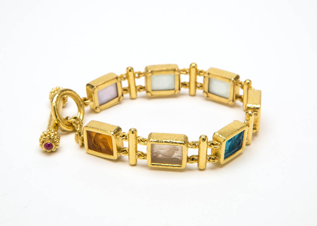 Jewel tone Venetian glass intaglios are featured in this classic Elizabeth Locke link bracelet with toggle clasp set with cabochon rubies. 7 1/2 inches in length
