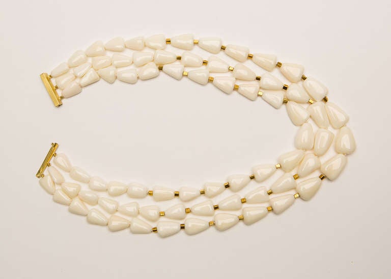 Simply chic.  Triple strand natural white coral necklace finished with 18k gold spacers and clasp.  Live in it, easy to wear, one of a kind!