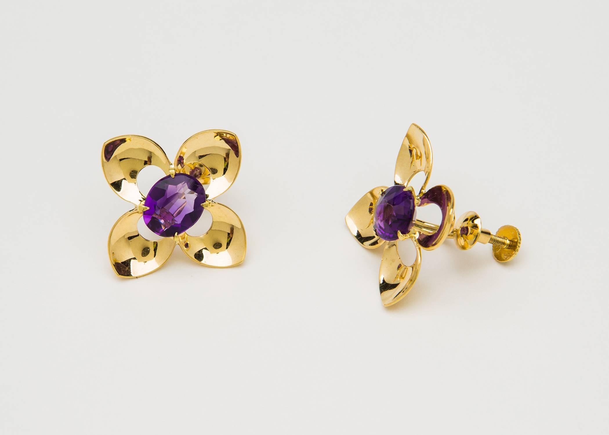 Pure Retro style is found in this pair of Tiffany & Co. earrings centering deep purple amethysts.  1 1/8 inches in scale