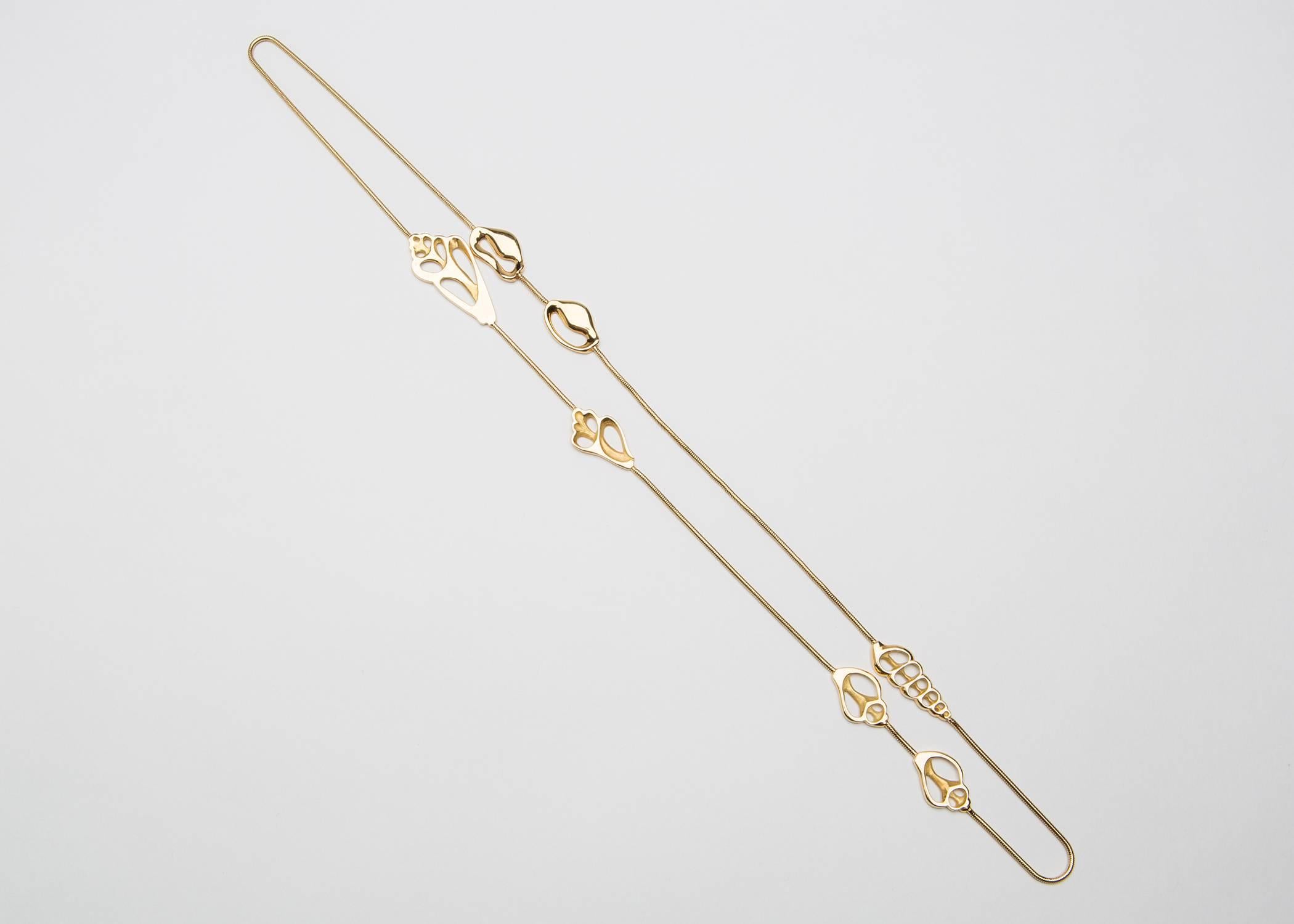Seven seashell slices combine to create an elegant and playful necklace. Angela Cummings Iconic designs created for Tiffany & Co. are very special and collectable. This is an early rarely available piece. 30 inches in length 43 grams of 18k gold