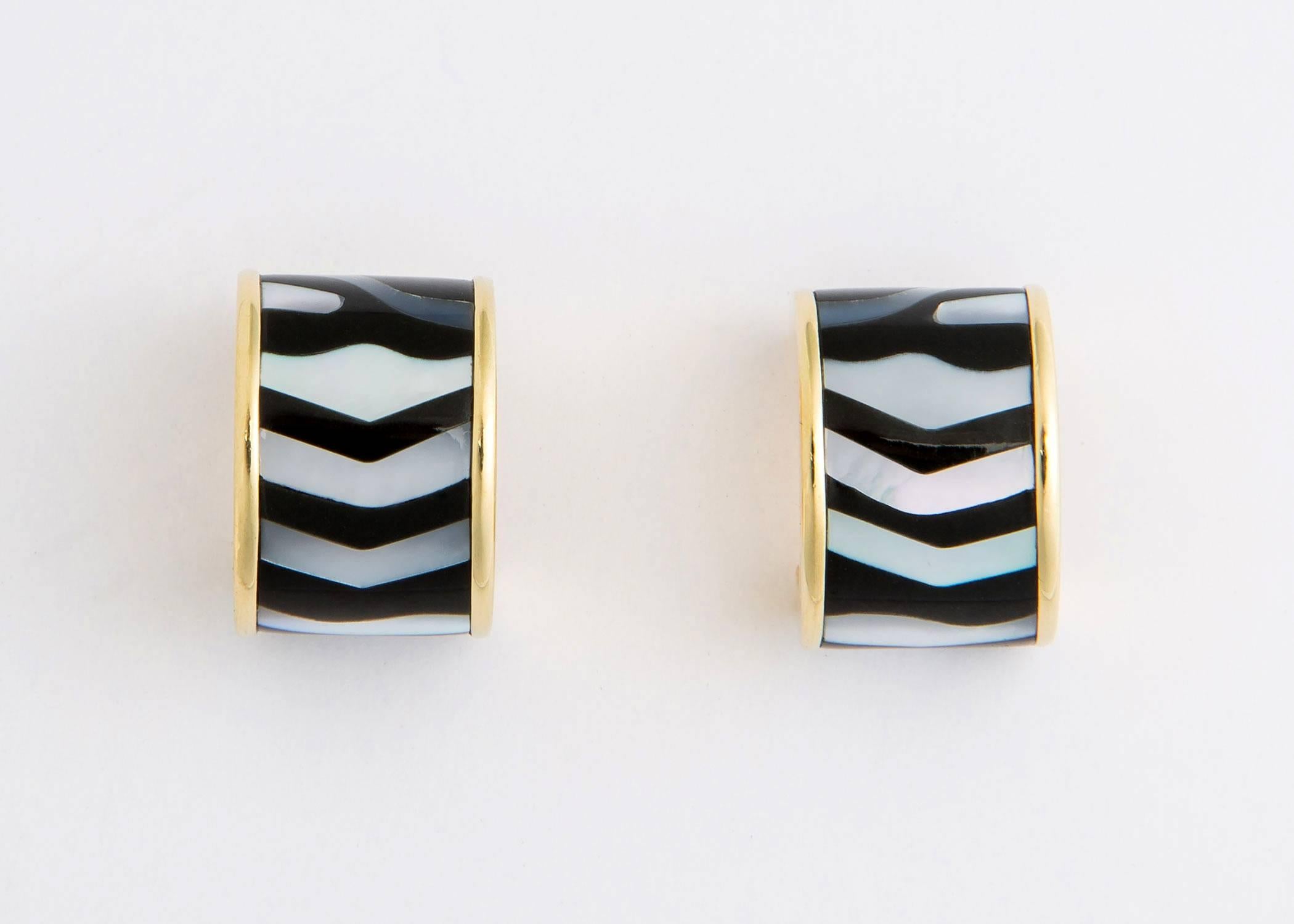 Simply Chic !!! Black onyx and mother of pearl create a smart wearable hoop earring. A great example of Tiffany and Co. design excellence. 1/2 inch across and 5/8's of an inch in length.