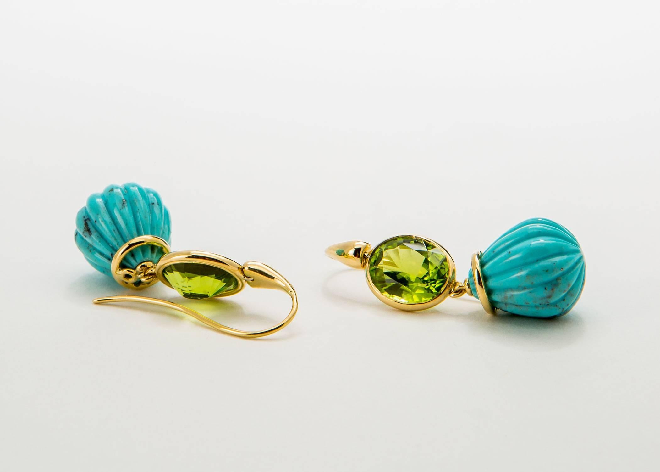 A matched pair of faceted peridots are framed with rich 18k gold and fluted turquoise drops are added creating a perfect color combination. These are completely handmade and one of a kind. 1 5/8's inches in length. 