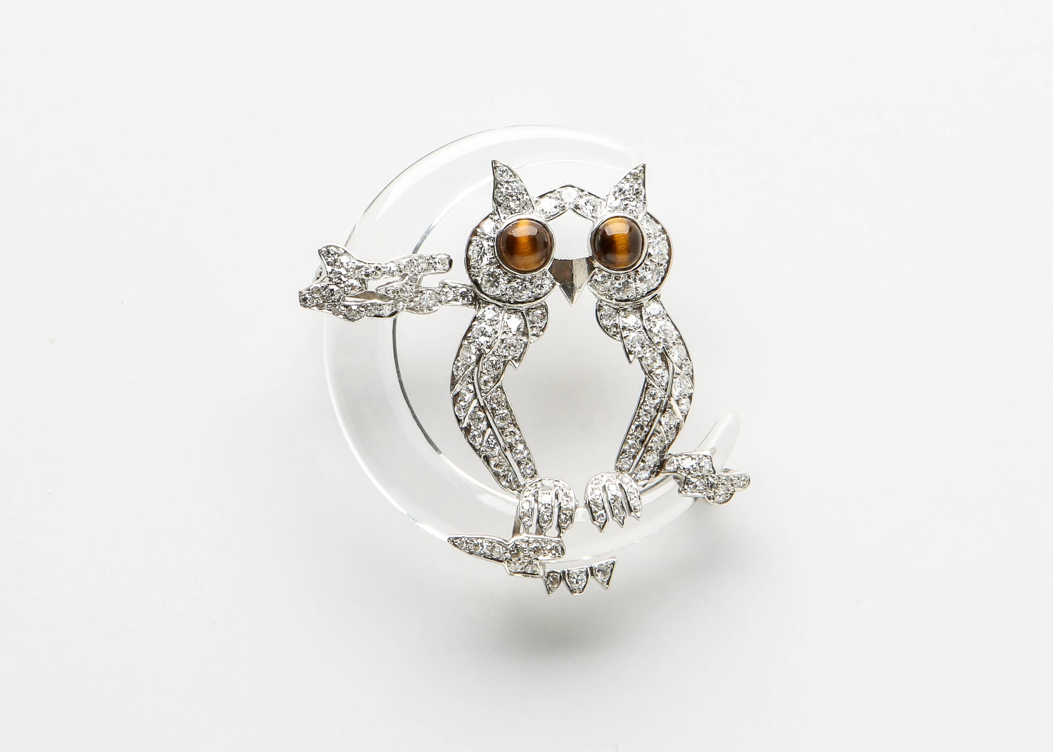 Rare and collectable. This handmade platinum and diamond owl imposingly perches on a perfectly carved rock crystal crescent moon. 1 5/8's in size. 