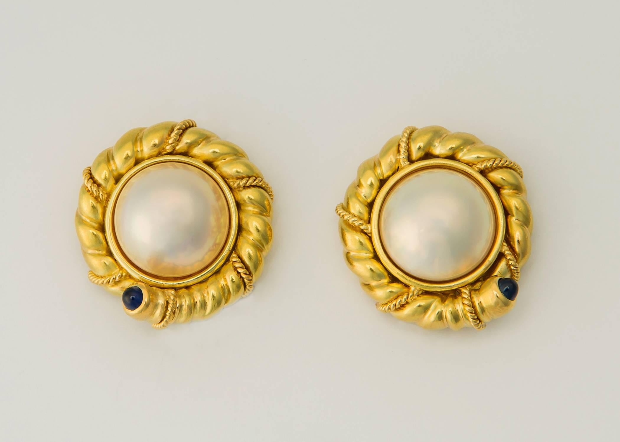 Tiffany style and quality. A beautiful 14.50mm mabe pearl is framed with rich 18k gold and finished with a cabochon cut blue sapphire. 7/8's of an inch of classic design. 
