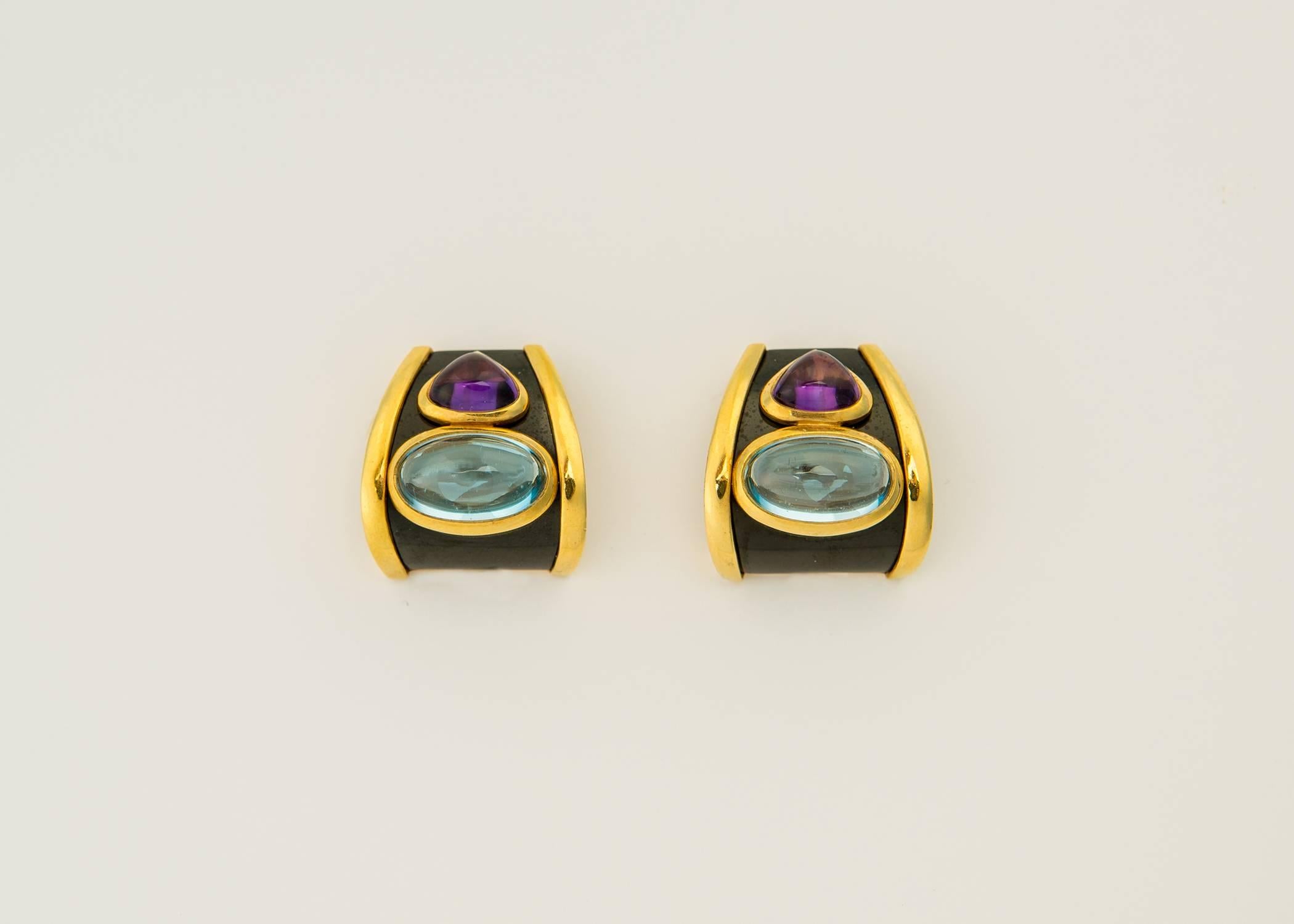 Bulgari granddaughter Marina B at her best. Vivid amethyst and blue topaz are set against black onyx and framed with rich 18k gold. Simply Chic. 7/8's of an inch in size.