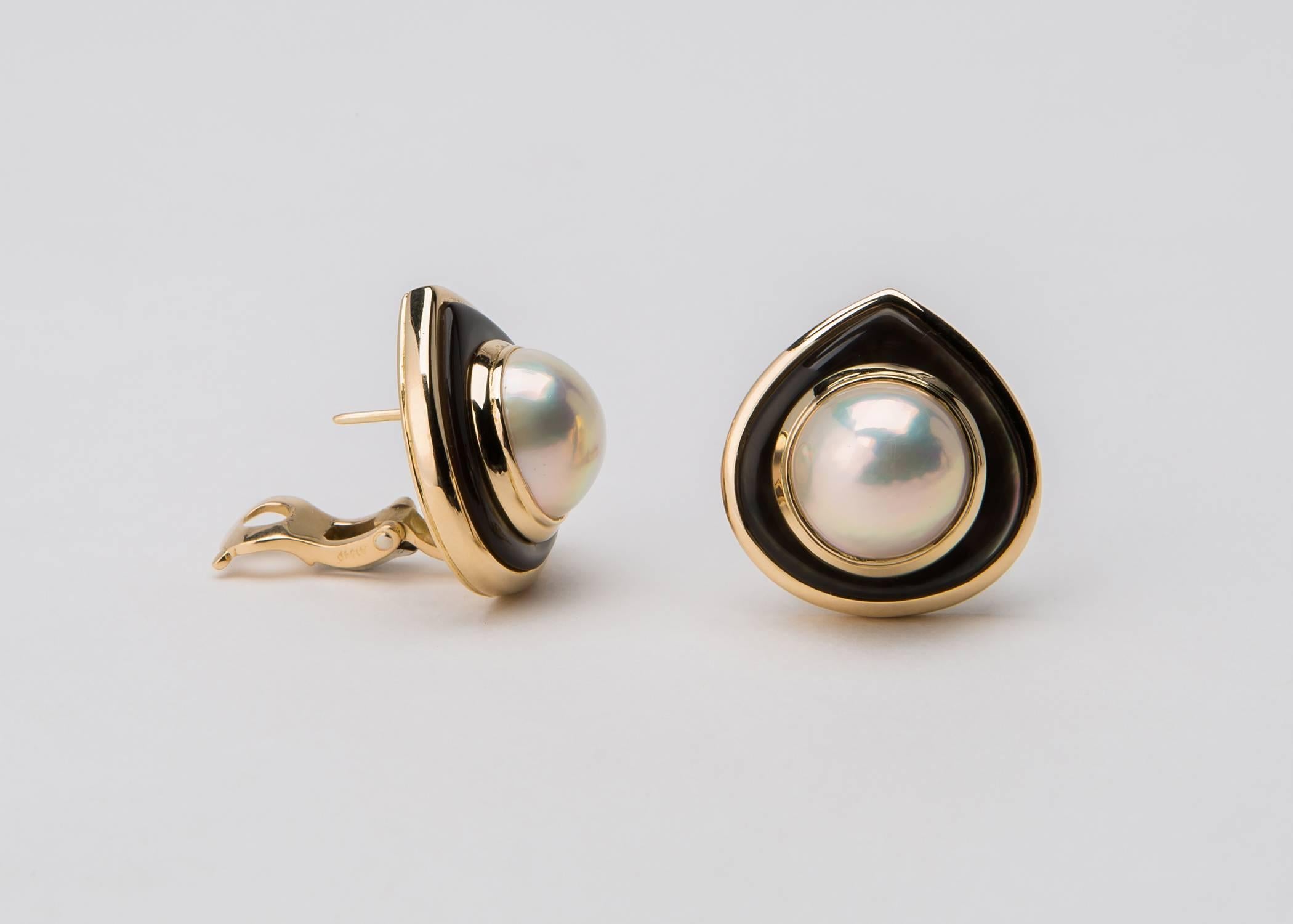 Marina B carries on the Bulgari tradition of great quality and design excellence. A 14.00mm mabe pearl is framed by brownish grey mother of pearl and rich 18k gold. 7/8's of an inch in size. The color of the mother of pearl in the first image is