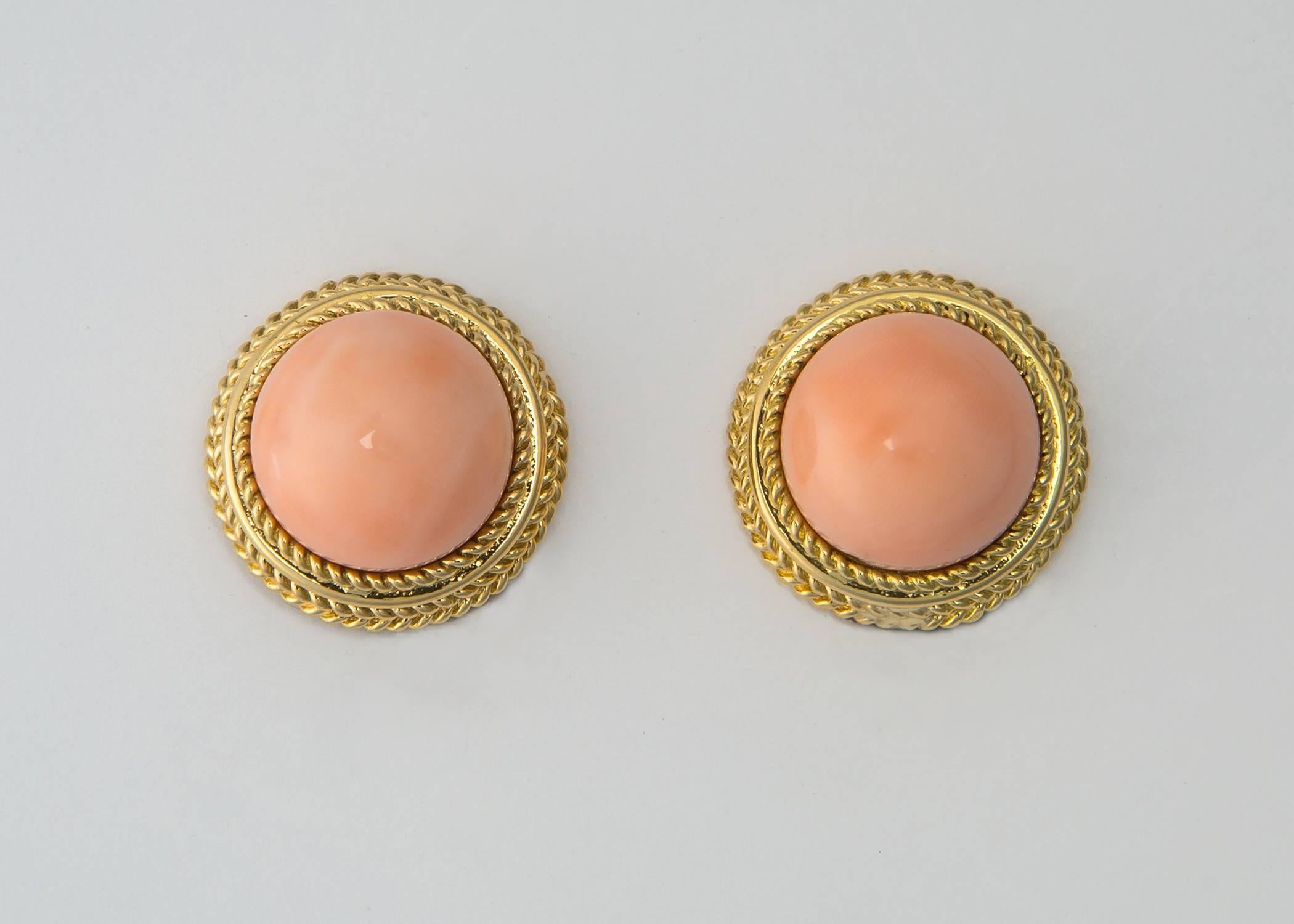 The color and tone of angel skin coral is beautiful and flattering for any complexion. Perfectly matched coral is firamed with rich 18k gold.  7/8's of an inch in size. 