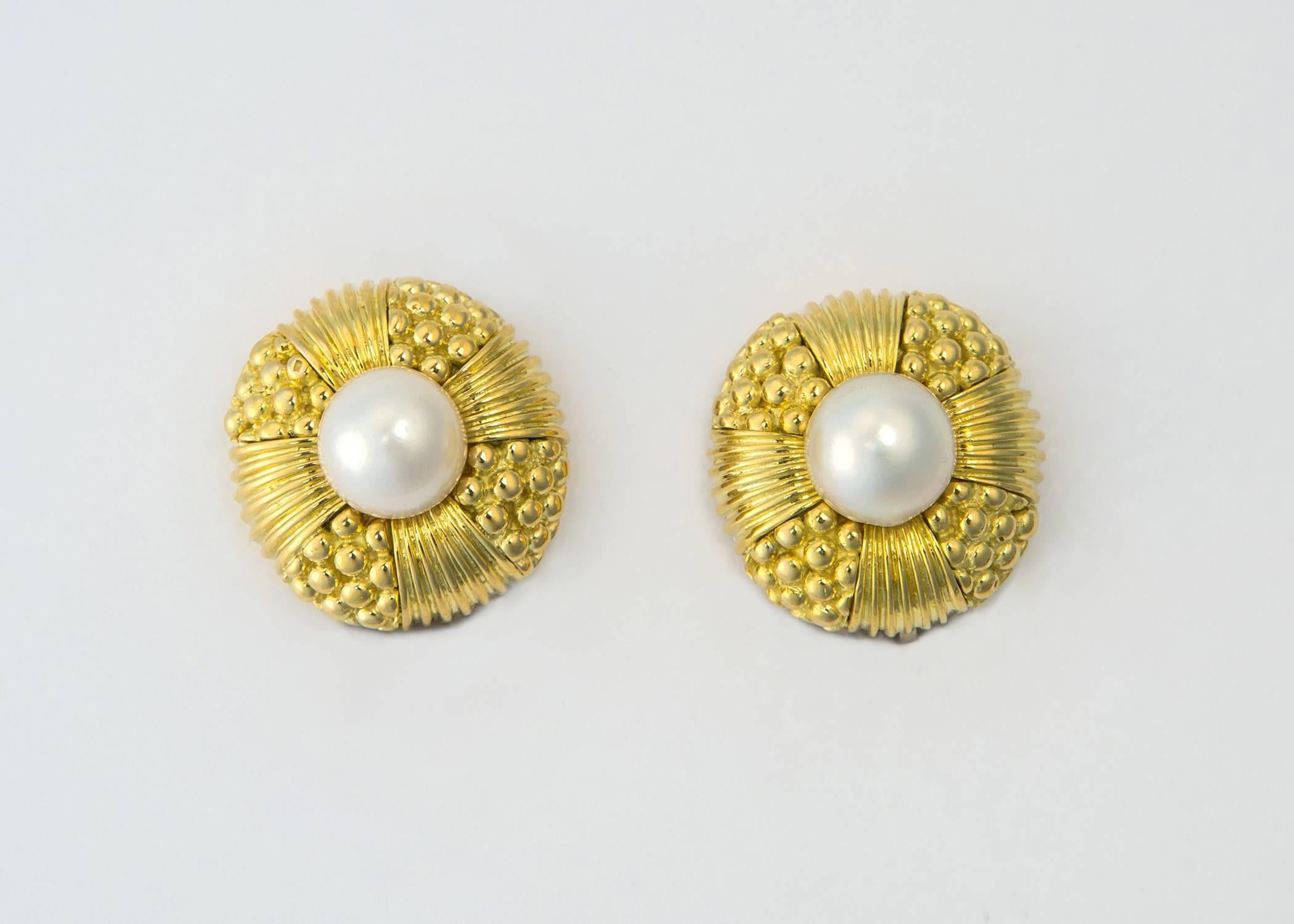 Simply elegant. A beautiful lustrous cultured pearl is framed with rich 18k gold. Exceptional detailing makes this simple classic earring special. 7/8's of an inch in size. 