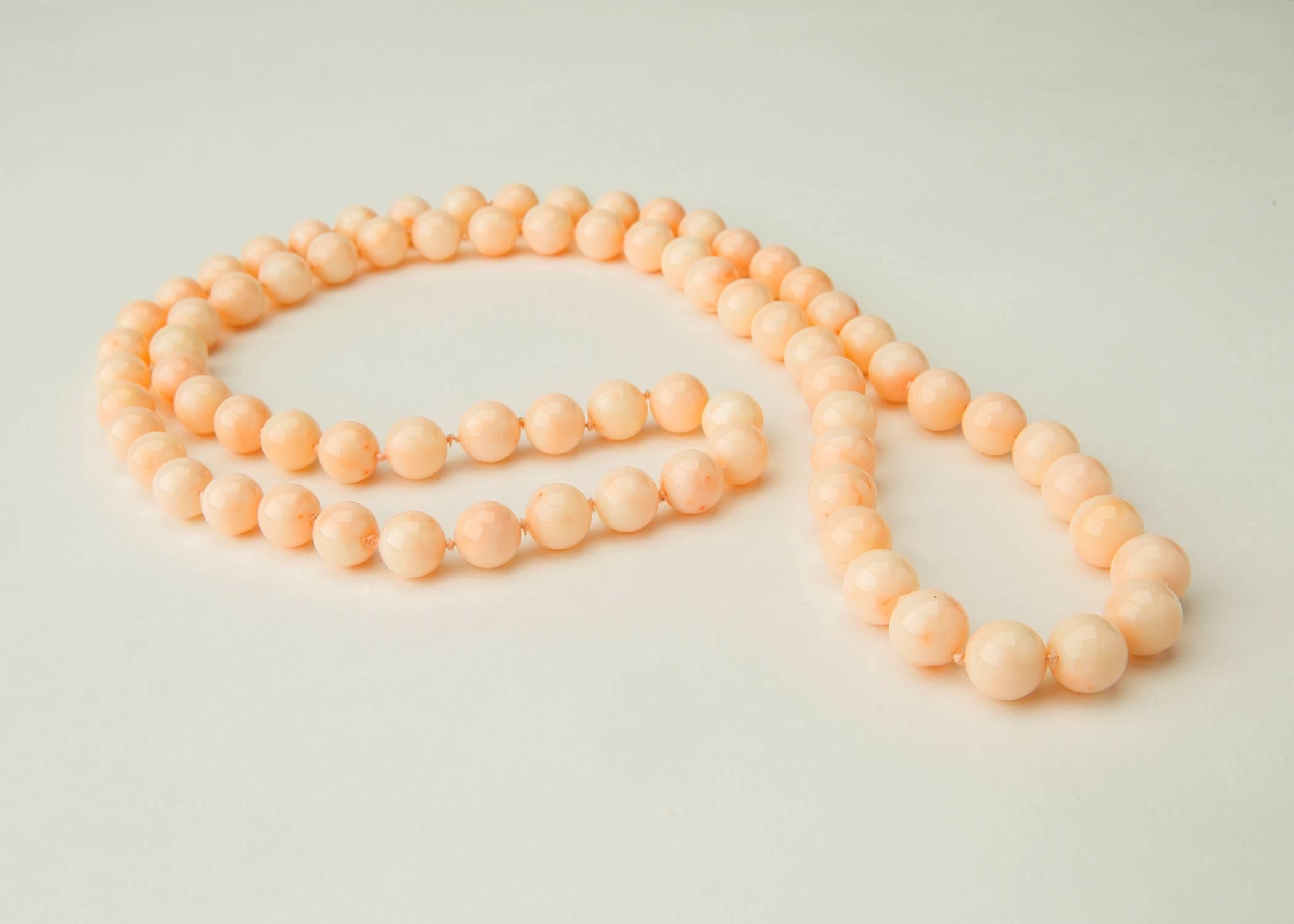 Classic opera length strand of beautiful angel skin coral beads. 77 beads 11.00 to 12.00 mm in size create this 38 inch necklace. 