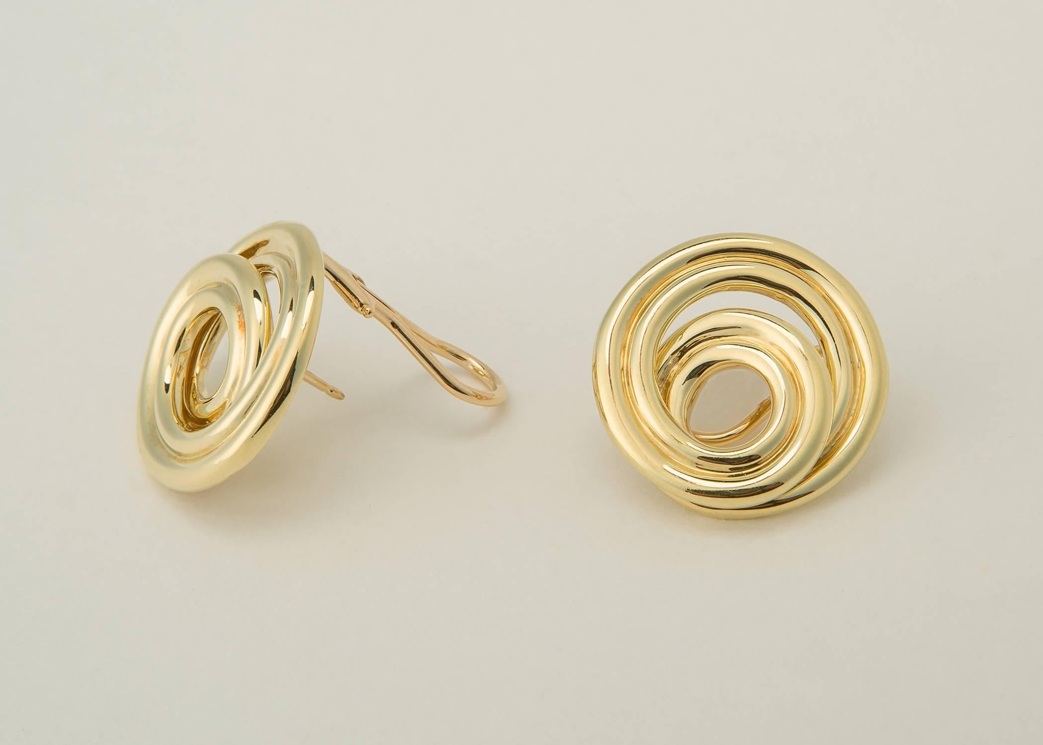 Simple and Chic. Tiffany & Co. creates an easy wearable earring with swirls of 18k gold. Tiffany quality and design all the way.  7/8's of an inch in size