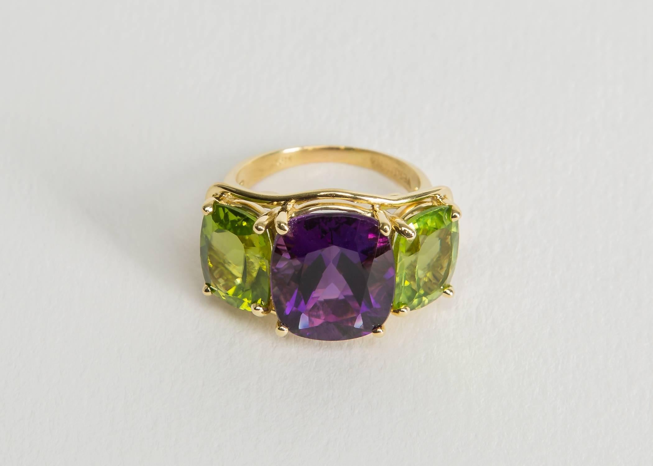 A Verdura classic. This is the larger of two sizes Verdura creates their classic three stone ring in. Rich amethyst is flanked by bright peridots. Chic and easy to wear. 