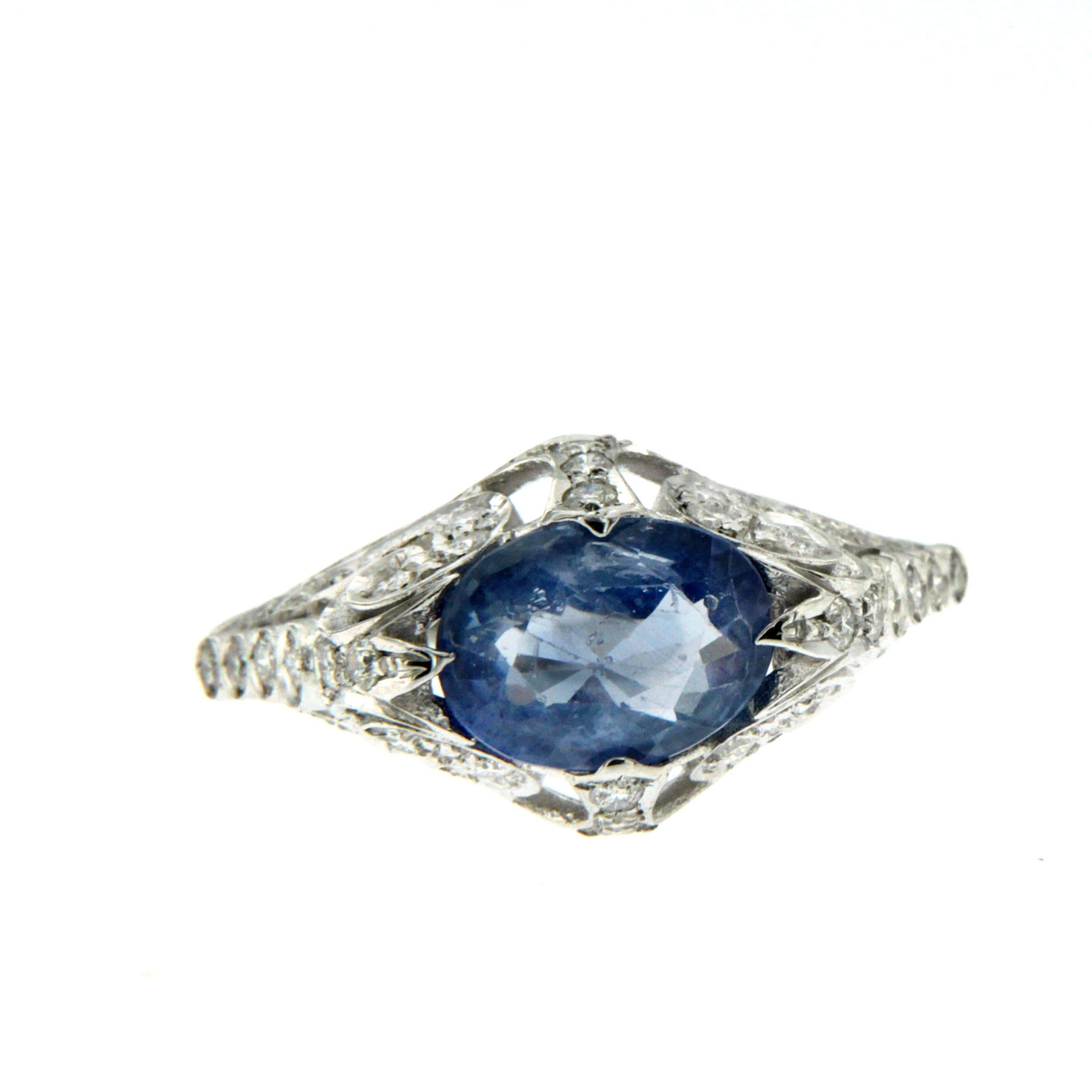 A sapphire and diamond ring, set with an oval mixed cut Ceylon sapphire, weighing an approx. 2.36cts, surrounded by old  mine-cut diamonds, weighing an approx. total of 0.75cts, with diamond set shoulders, mounted in 18k white gold.

Gross weight: