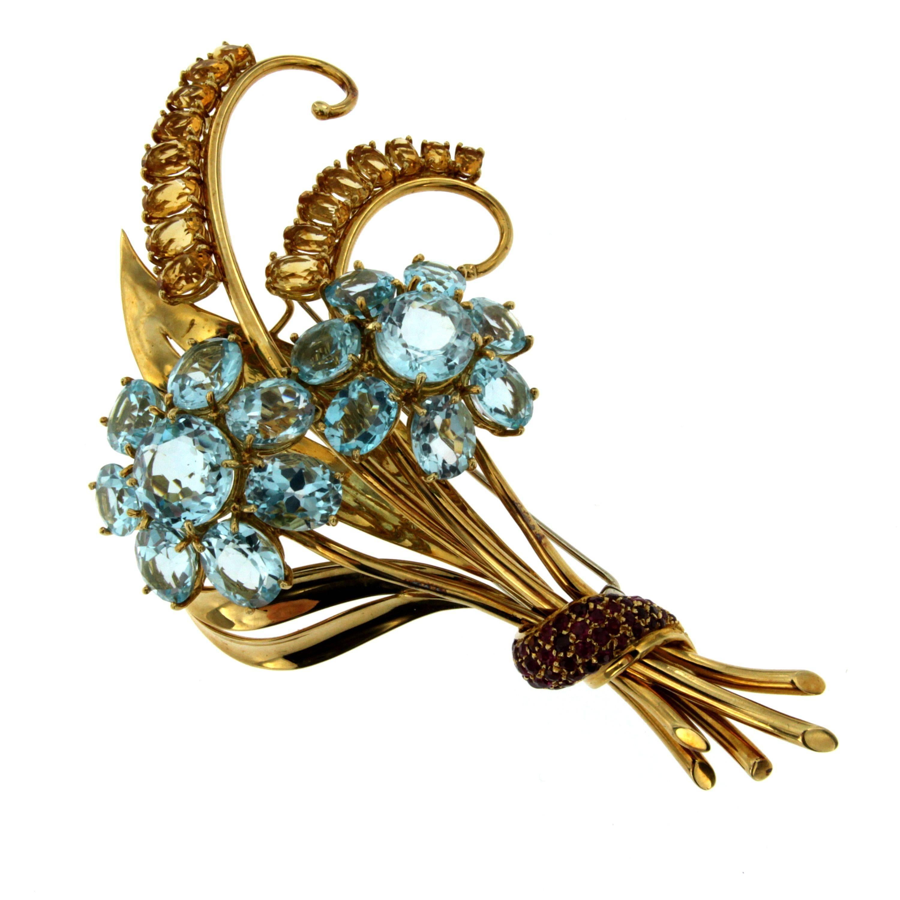 A fabulous 1950s Retro signed flower brooch set with 16 blue Topaz weighing approx. 40ct, 16 Citrine total weight approx. 13ct and natural Rubies weighing approx. 2.00 total carats. 
Handmade 18k yellow gold mounting;  
The clip is stamped with