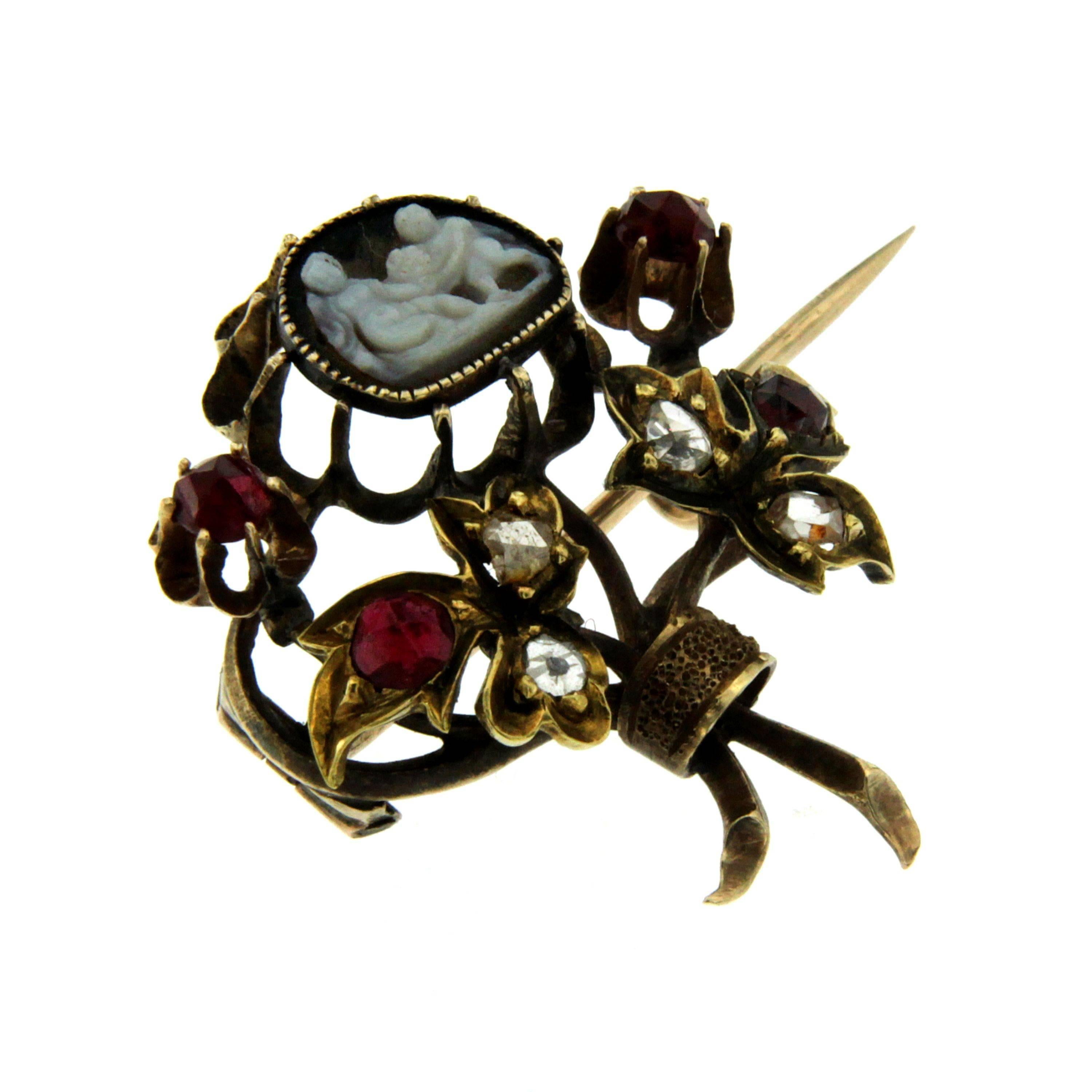 Exquisite authentic Georgian brooch, dates 1800' - Origin England
It features a flowers bouquet with a shell cameo in the center and all around rose cut Diamonds and red gems.

This unique piece is designed and crafted entirely by hand in the