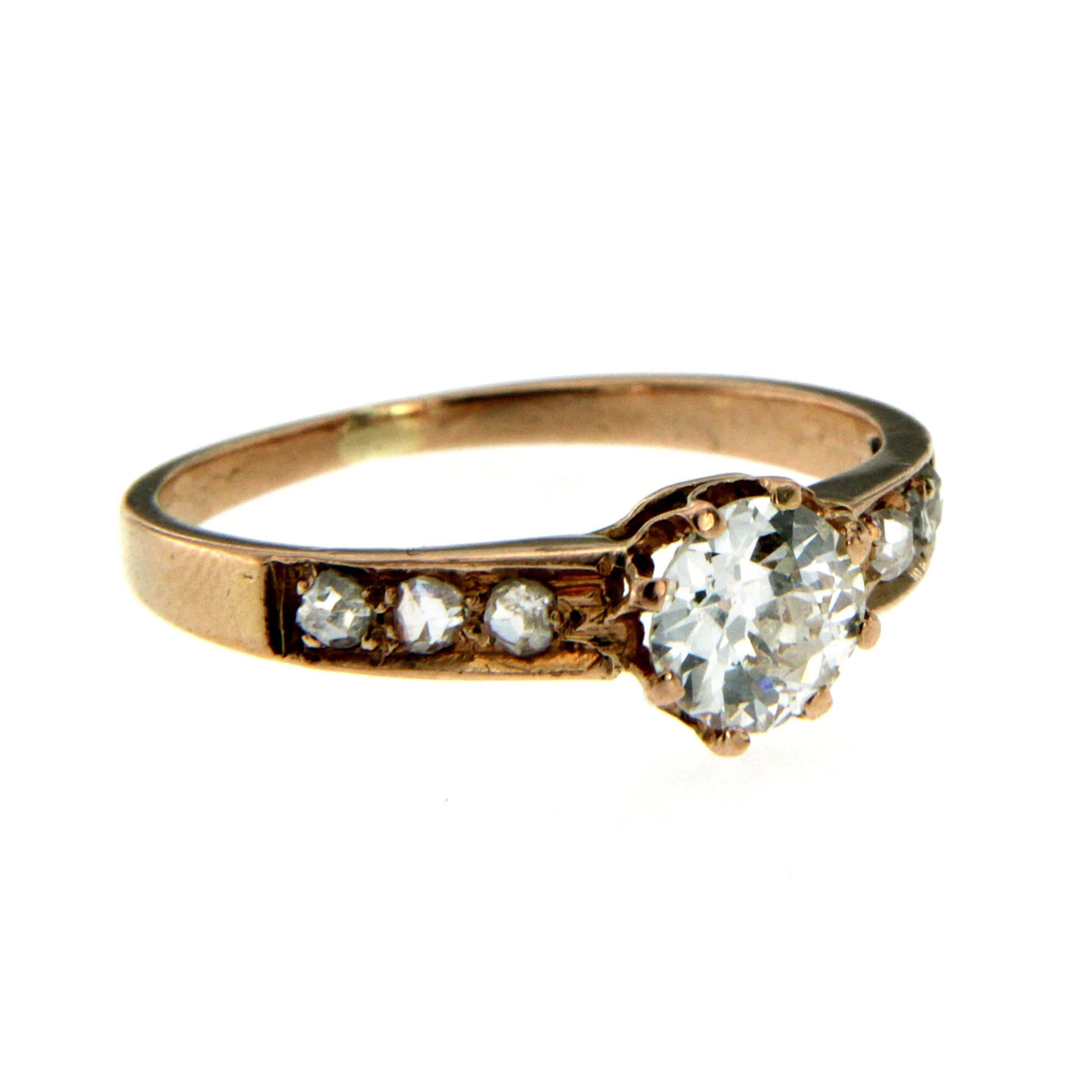 Rose 12 k gold ring, handcrafted in England circa 1910

It is set with one large and sparkling old mine cut Diamond in the center weighing 0,65 carat of great quality, graded H color Vs and 6 rose cut diamonds on the sides weighing 0,15