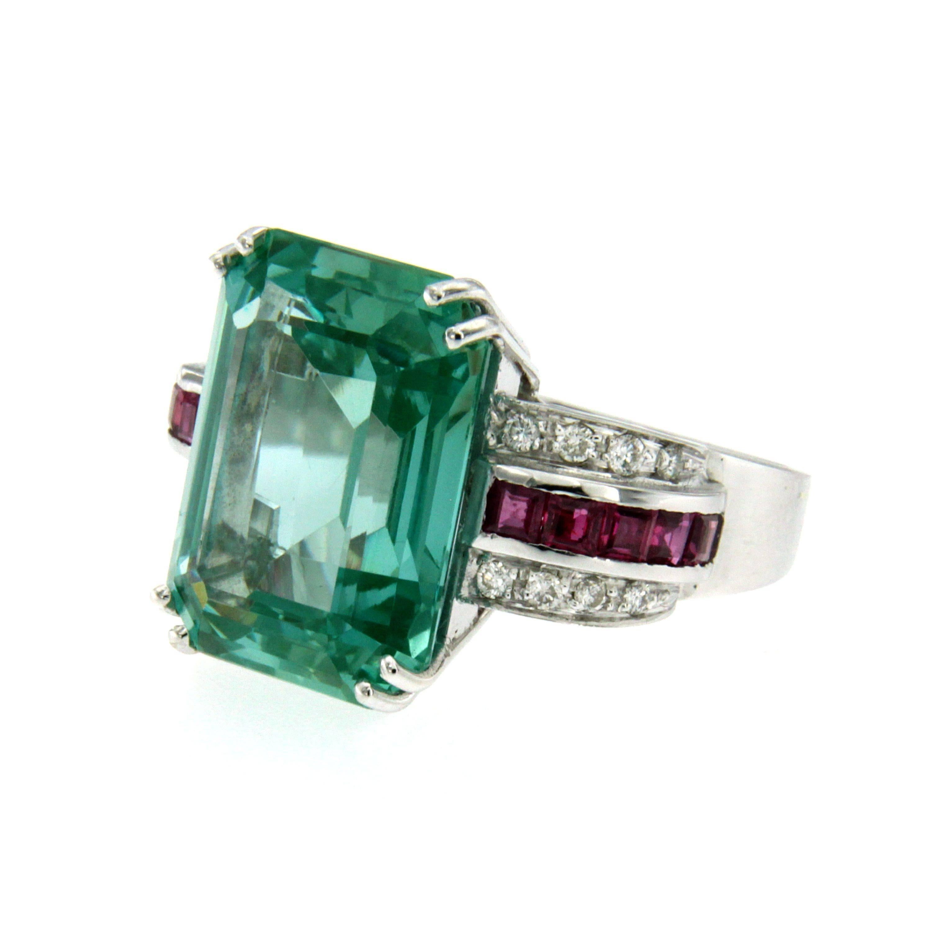 Stunning gold ring of great quality dates 1940, origin Italy, all handmade.

It is set in the center with a wide, rare and beautiful natural Green Aquamarine approx. 9 carats, and surrounded by approx. 1.20 carat of fine custom cut Rubies and 0,40