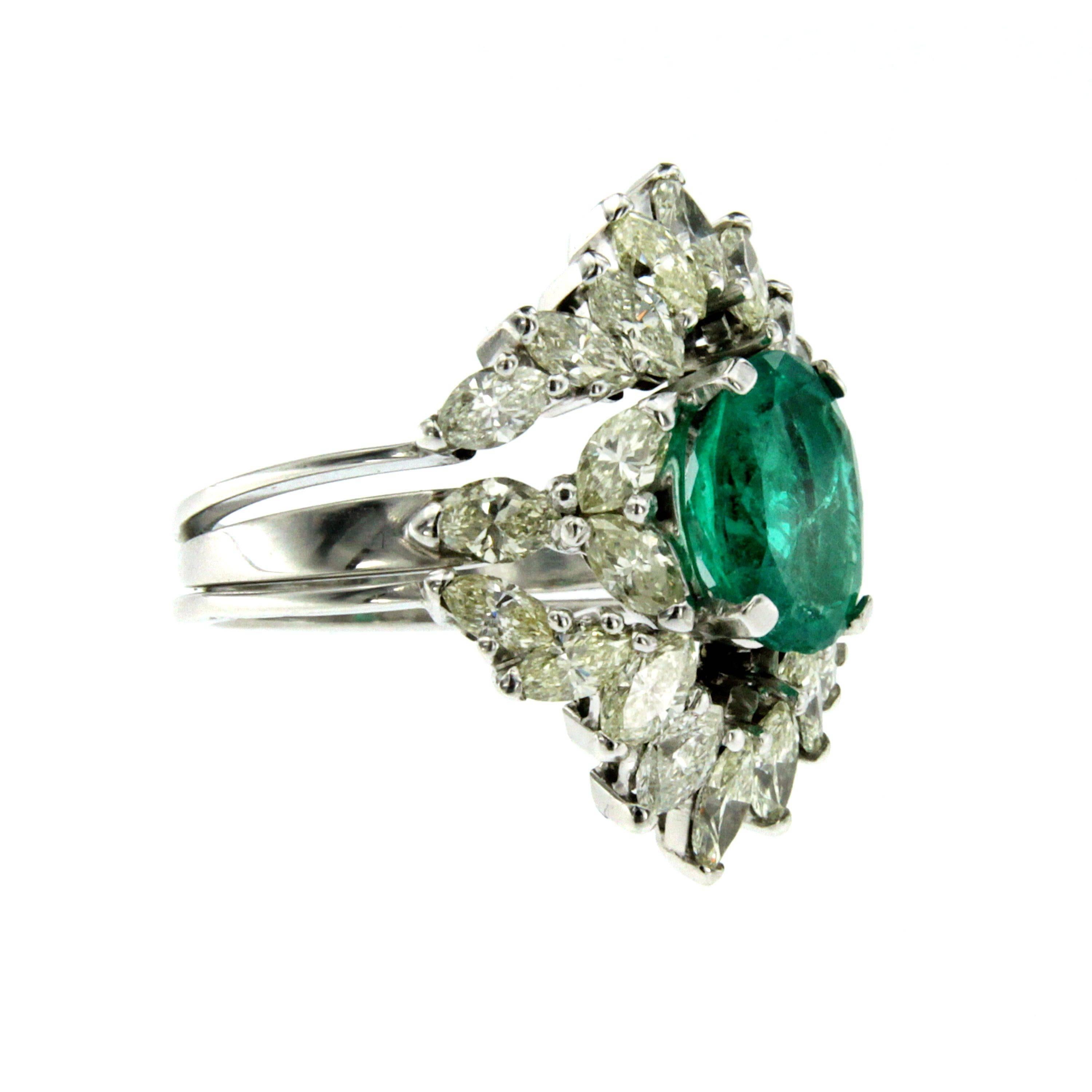 Stunning engagement ring centering an oval cut natural Colombian Emerald weighing 3.50 carat, flanked by 2.50 carats of navette cut diamonds J color VS. Mounted in 18K white gold.

CONDITION: Pre-owned - Excellent
METAL: 18k White Gold
GEM STONE: