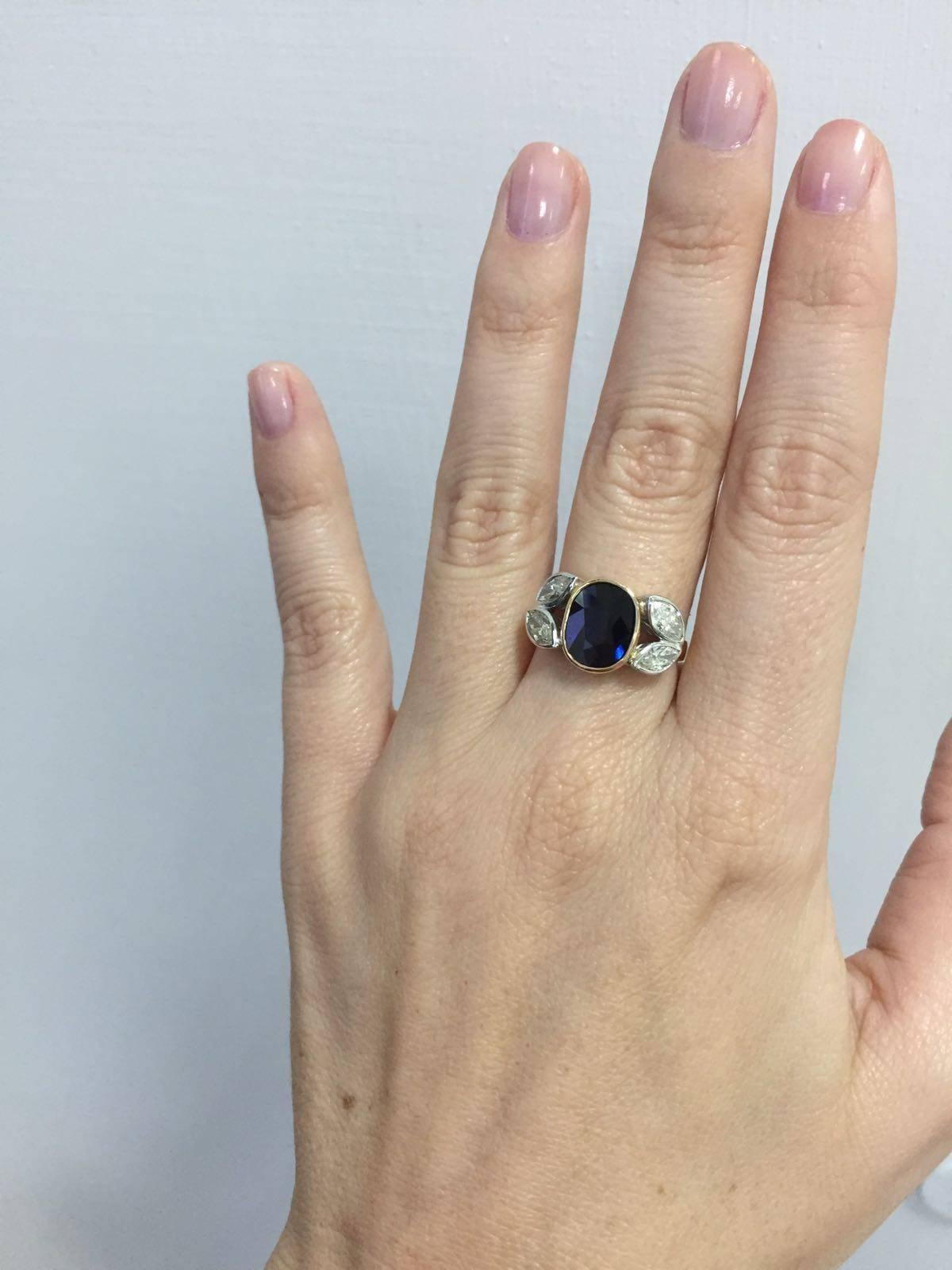 18k Yellow and White Gold Ring feauturing a beautiful Natural Blue Sapphire weighing approximately 3.00ct accented by four sparkling marquise cut diamonds weighing approximately 1.50ct total. graded G/H Vvs1

Gross Weight: 6.3 gr
Origin: France
Ring