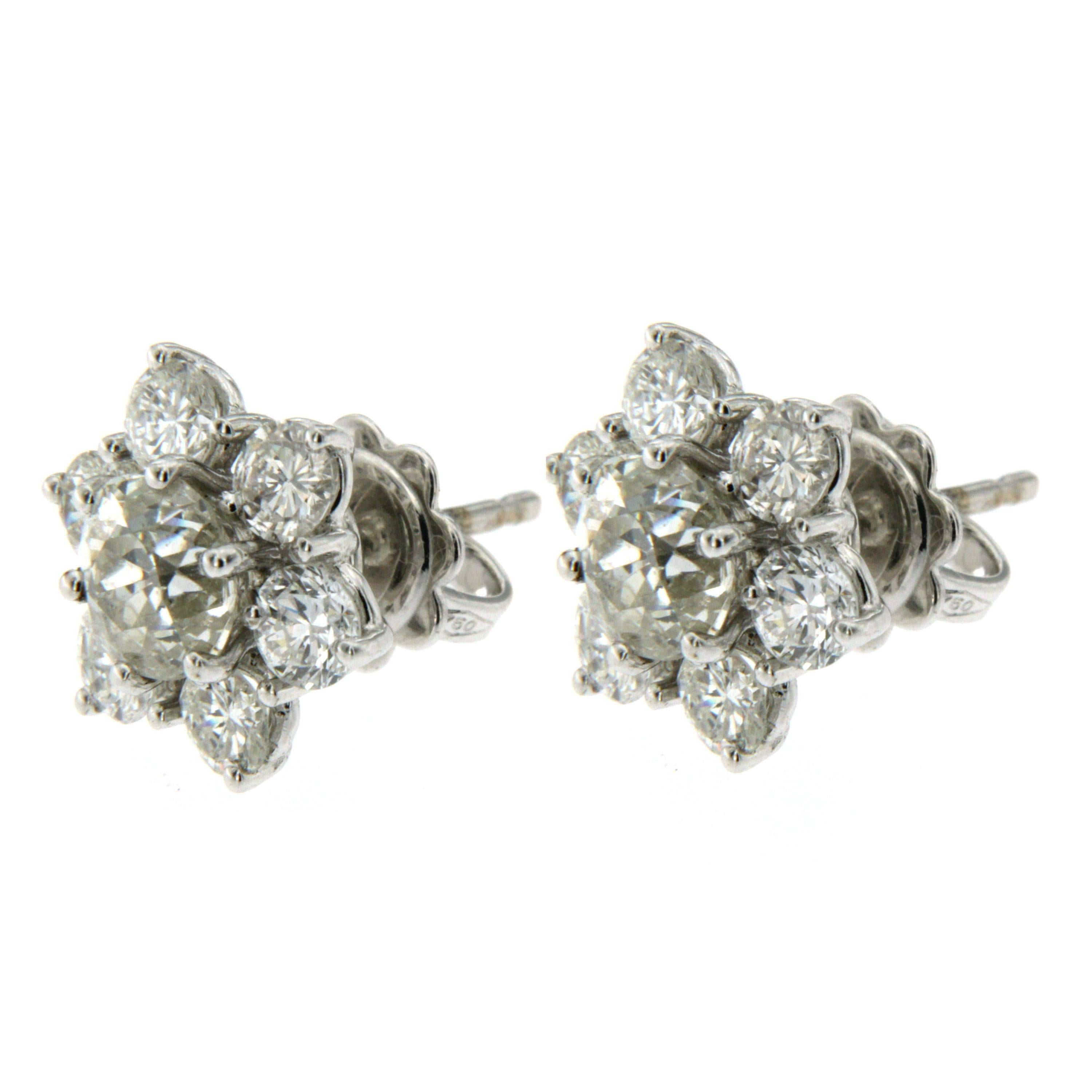 This Gorgeous Diamonds cluster earrings are set with an old mine cut diamond a little less 2 carat for a total. 1.96ct -  surrounded by 12 old mine cut diamonds, for an approx.weight of 1.80 carats.
Approx. total diamond weight 3.76 carats. 
The
