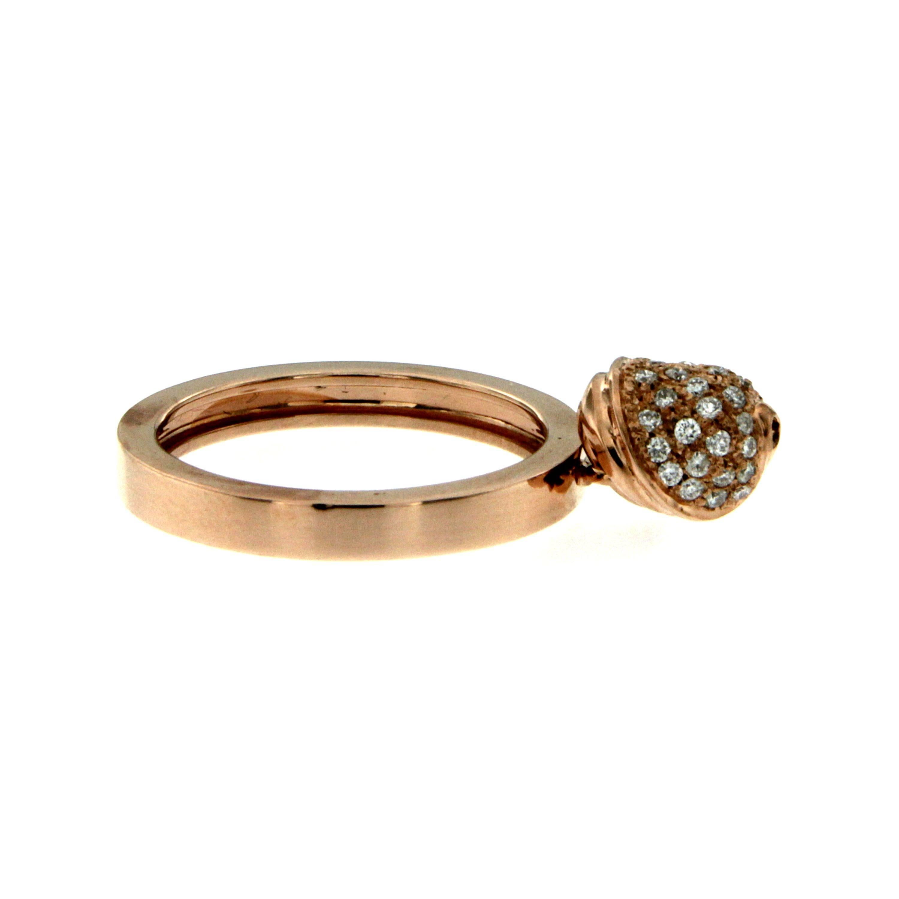 18k Rose Gold domed band supports a movable  head set with 0.30 ct of sparkling diamonds, that swings around as the wearer's hand moves. 
On the other side the ring features a single burnished diamond of 0.08 ct.
Adorable.

Gross weight: 7