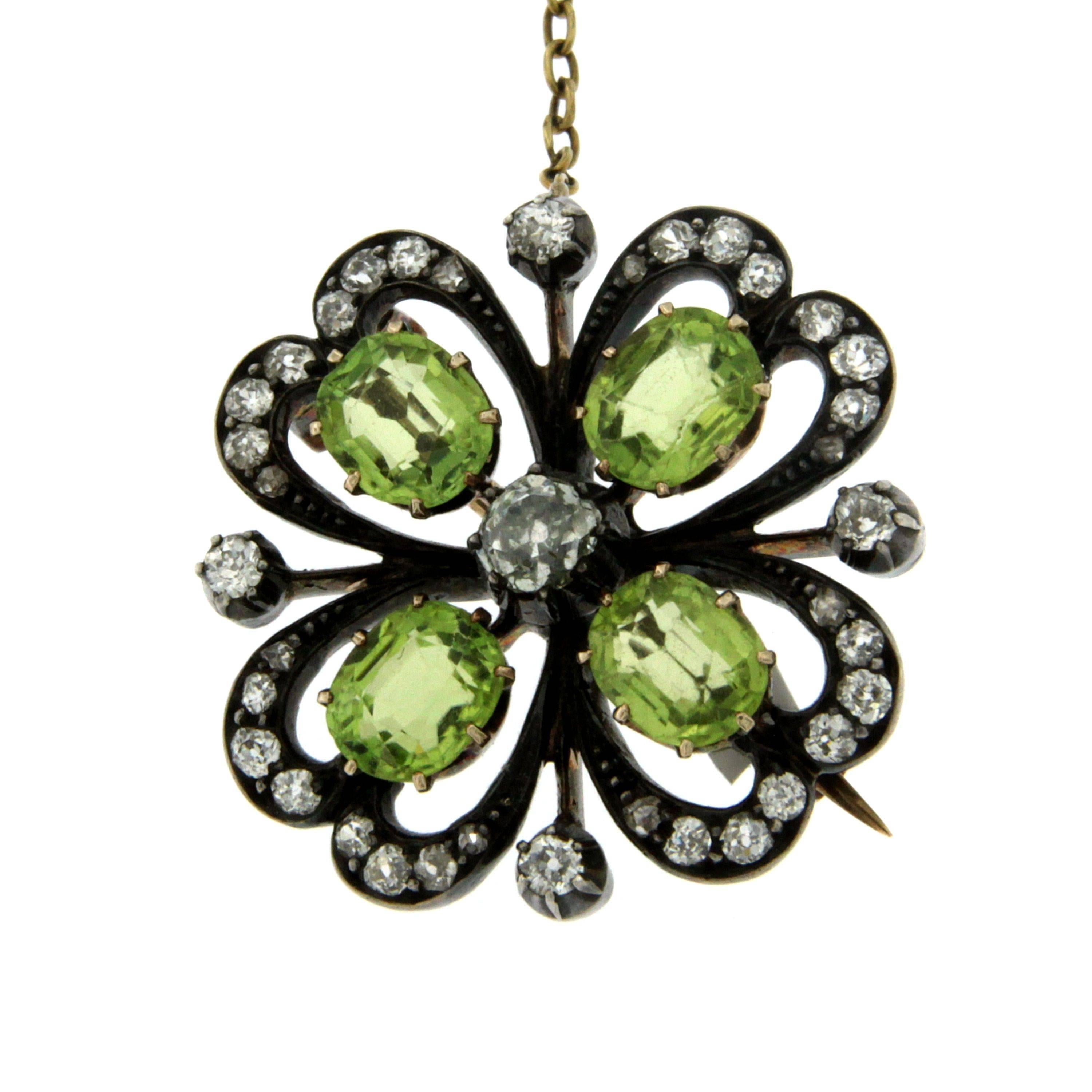This floral design antique brooch has been crafted in Silver and 12k Gold and it features approximately 6.00 cts of Peridot and 1 cts of old mine cut Diamonds.
The brooch secures to the reverse with an hinged pin and safety clasp and benefits from
