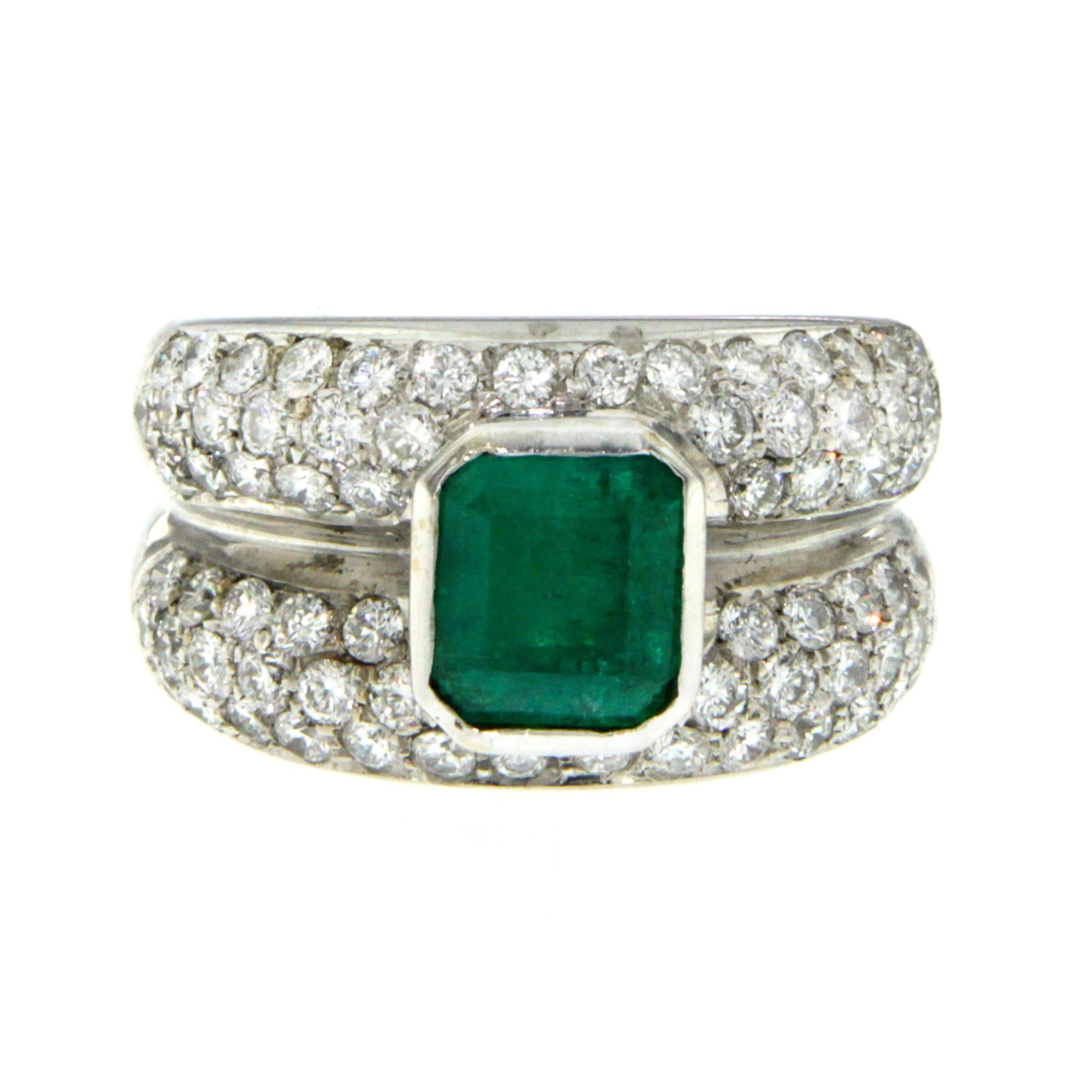 This beautiful handmade Emerald & Diamond Ring is crafted in 18k white Gold and it weighs approx. 18.8 grams.
The ring is set in the center with an Emerald-cut Colombian Emerald weighing approx. 2.50 carat  surrounded by 3 lines at each side of
