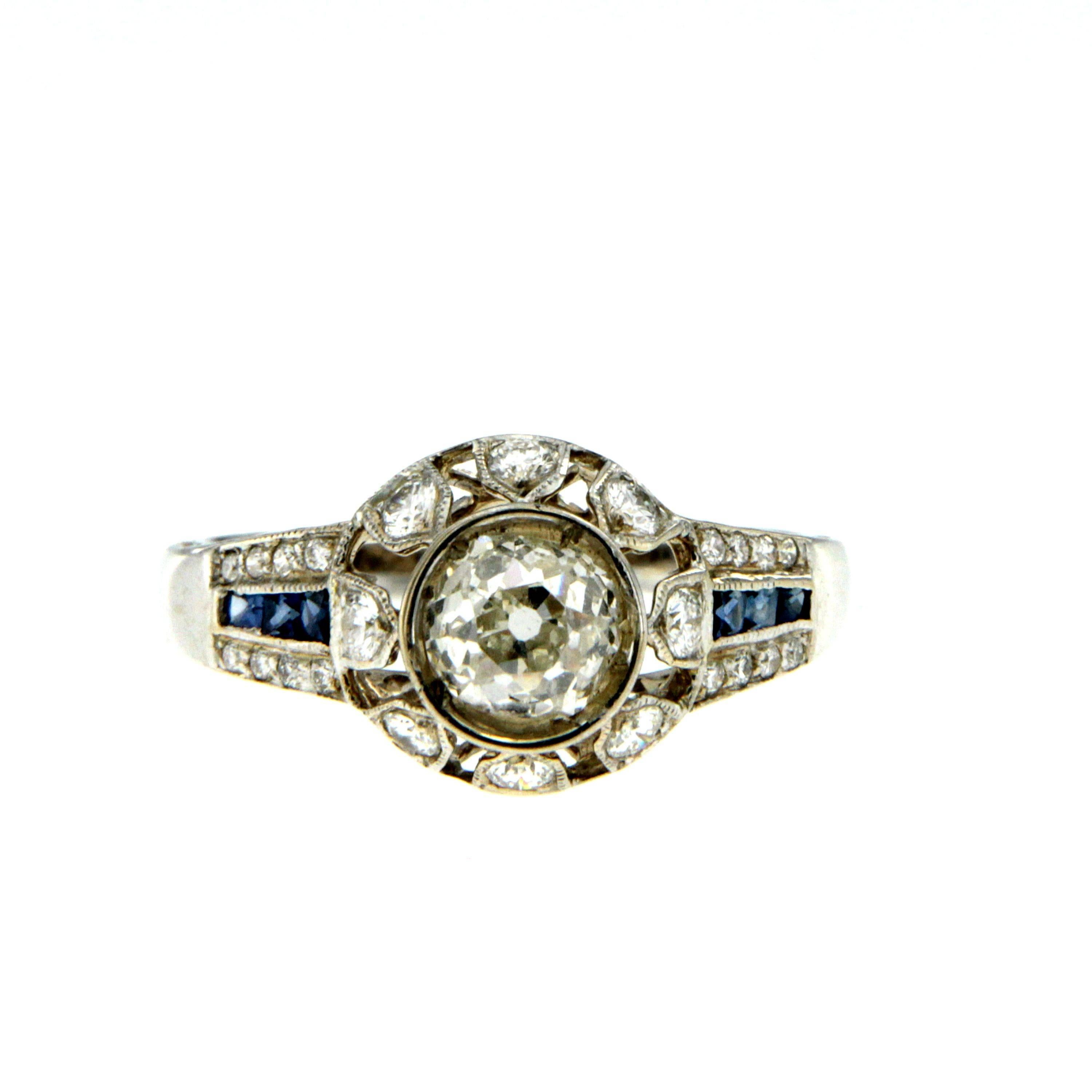 An Antique Art Deco 18k Gold Diamond & Sapphire Ring featuring a stunning 0.90ct. old mine cut Diamond with VS1 Clarity I Color, surrounded by 0.50ct. of diamonds and 0.20ct square cut Sapphires.
The ring has rigorous quality workmanship .
Gross