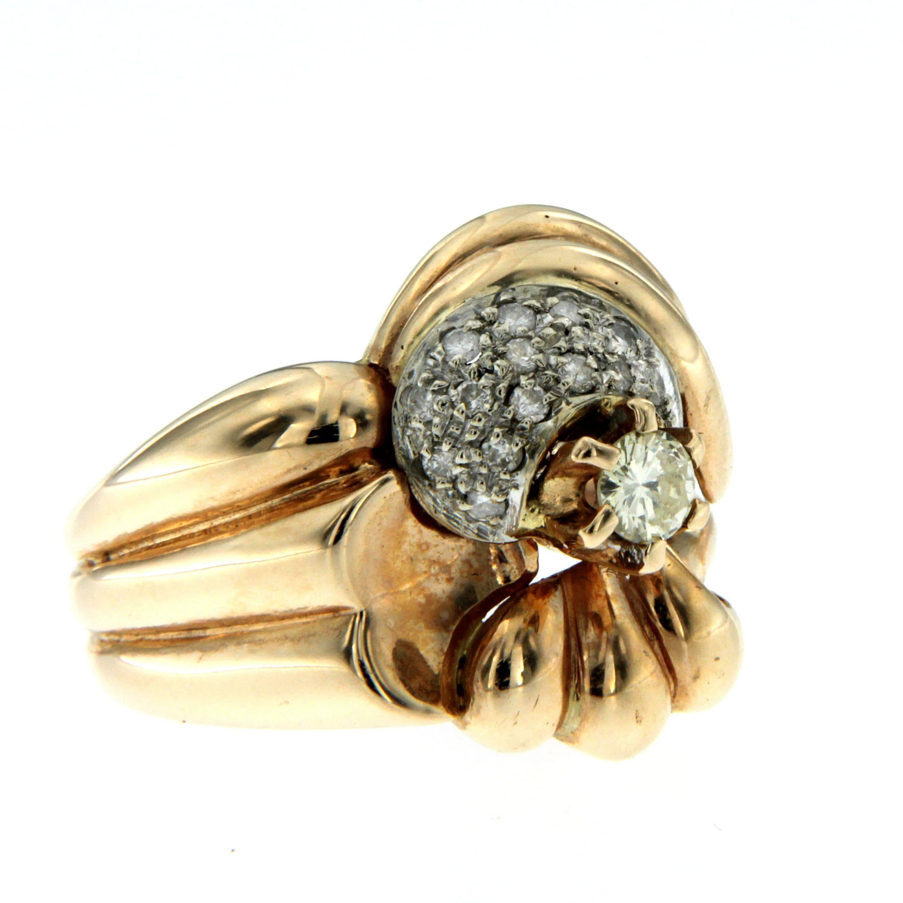 18-karat Gold and diamond ring, circa 1950

Smooth rounded surfaces ring designed with a central old mine cut Diamond weighing 0.40ct  flanked by 14 old mine-cut Diamonds for a tot. weight of .15ct.  
Very nice, in great condition.
Size US 7/7.5