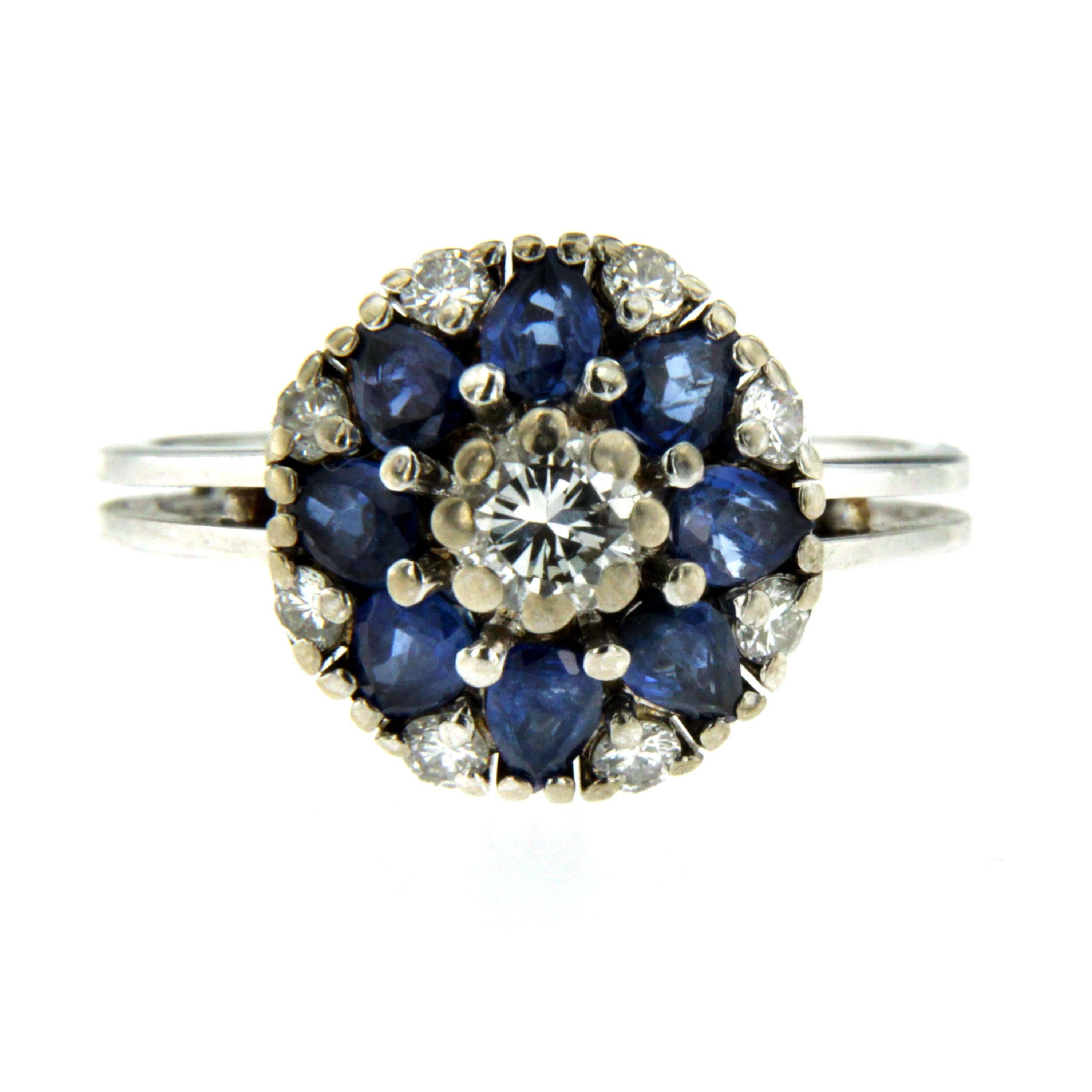 A gorgeous 18k Gold Sapphire Diamond Ring featuring a 0.25ct. round cut Diamond, surrounded by 8 oval cut sapphires weighing 3.20ct. and 8 round cut diamonds weighing 0.16 total carats. 
Gross weight: 5.4 Grams 

The ring is in great condition