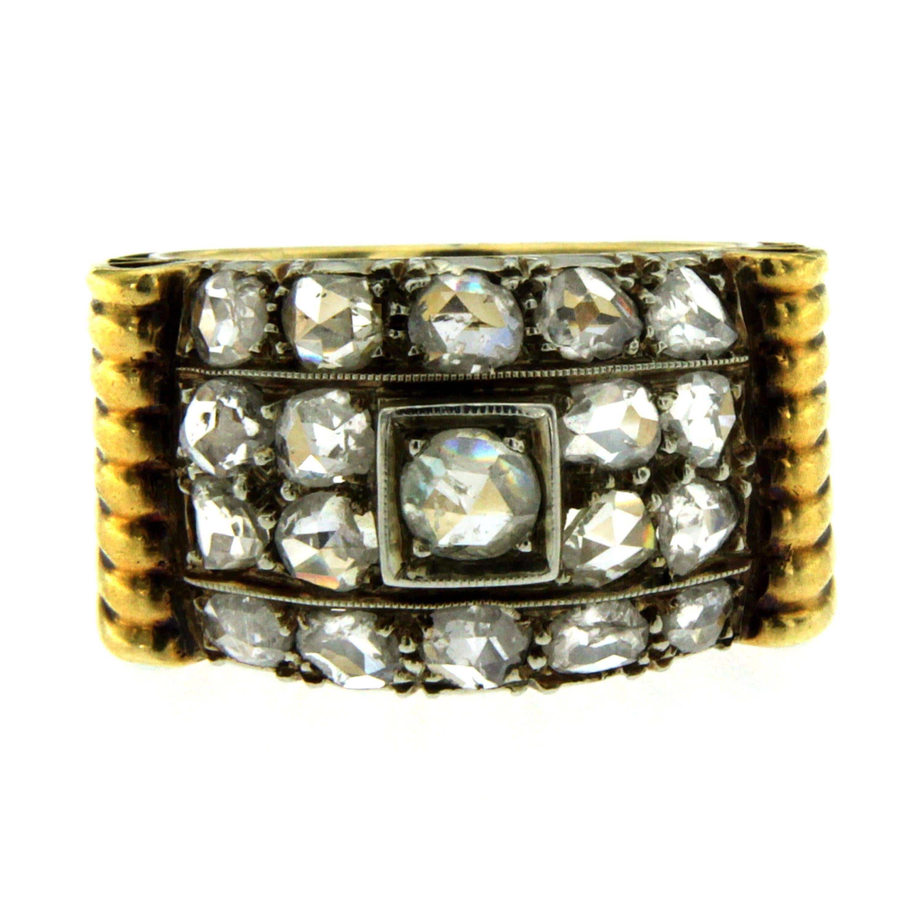 An Authentic Retro ring, original from 1940, made in Italy, mounted in 18k yellow and white gold.

The ring has a wide, textured band comprised of ridged grooves that travel around the entire outer surface, in the center there are three horizontal