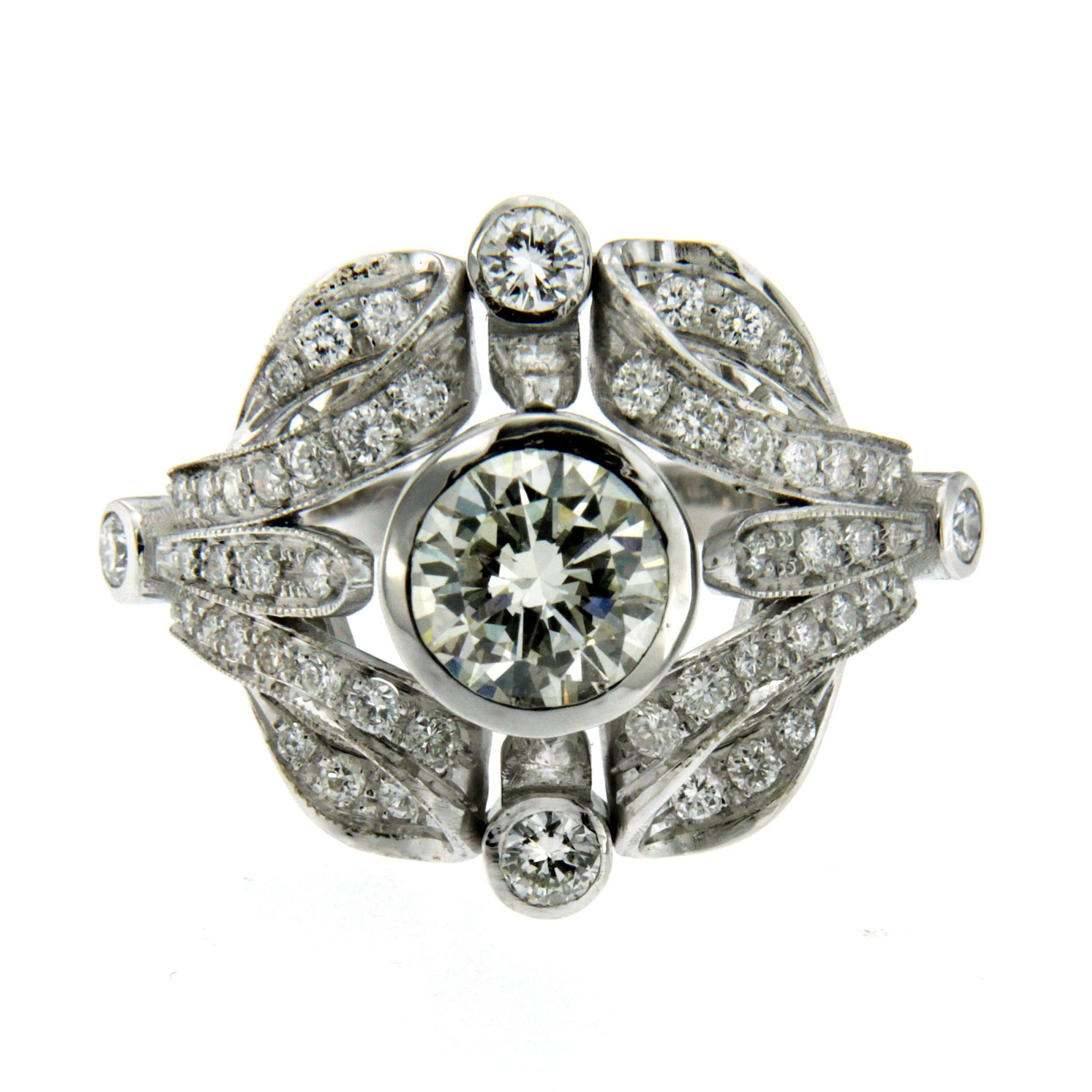Authentic Art Deco engagement ring. 
The ring is centered with a prominent 1.50cts old mine-cut diamond, graded J color and VS1 clarity, surrounded by 54 round cut diamonds, weighing cumulatively 1.07 cts, graded G-H color and VVS. Circa