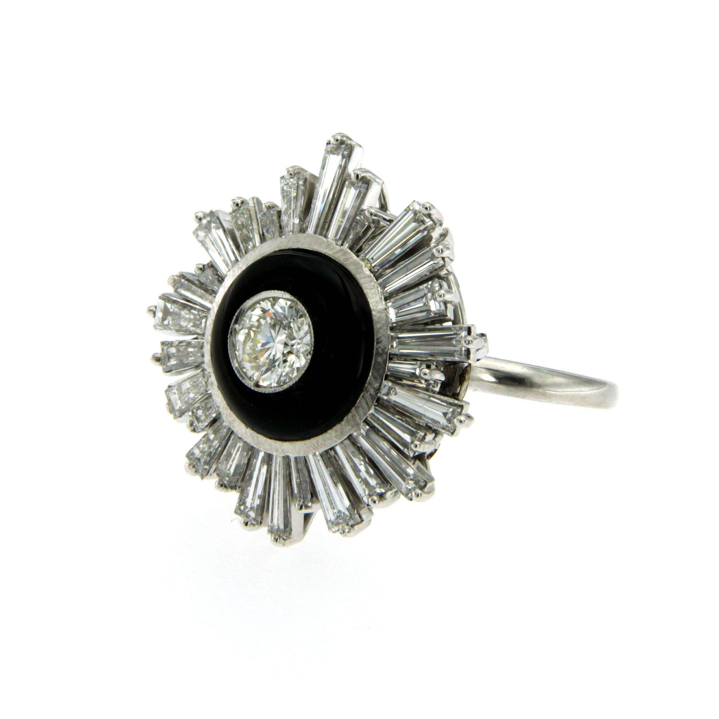 An art deco style diamond ring in 18k white gold. Centered by a 0.58 carat old mine cut diamond H-I color VVS,  surrounded by onyx and 2.30 carat baguette cut diamond detailing F-G color VVS.

CONDITION: Pre-owned - Excellent 
METAL: 18k White