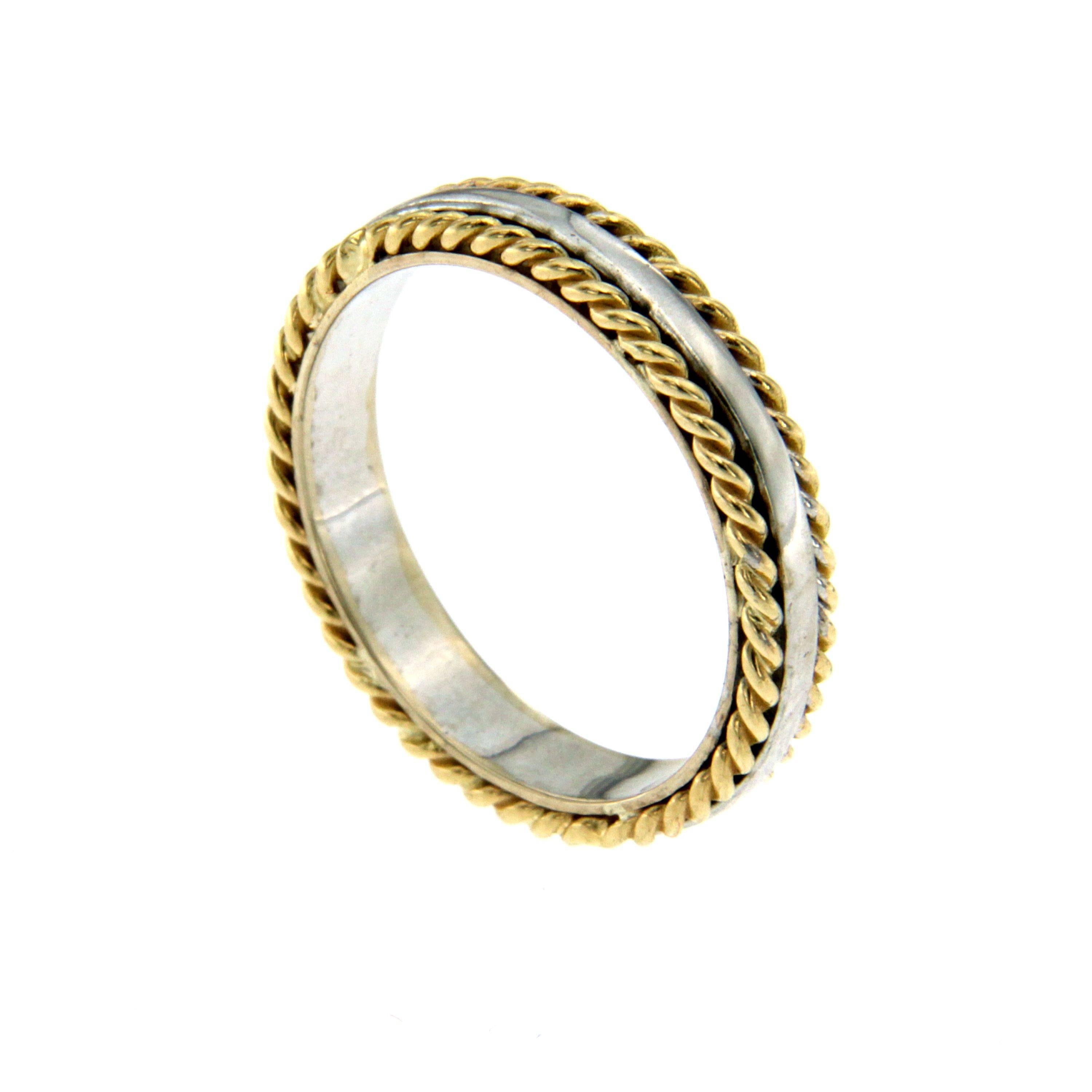 A gorgeous 18k gold band ring comprised of a high polished white gold background, upon which are soldered two twisted yellow gold rope motifs.

CONDITION: Brand New 
METAL: 18k Gold
DESIGN ERA: Contemporary
RING SIZE: US 6 - IT 12 - FR 52 - UK M,