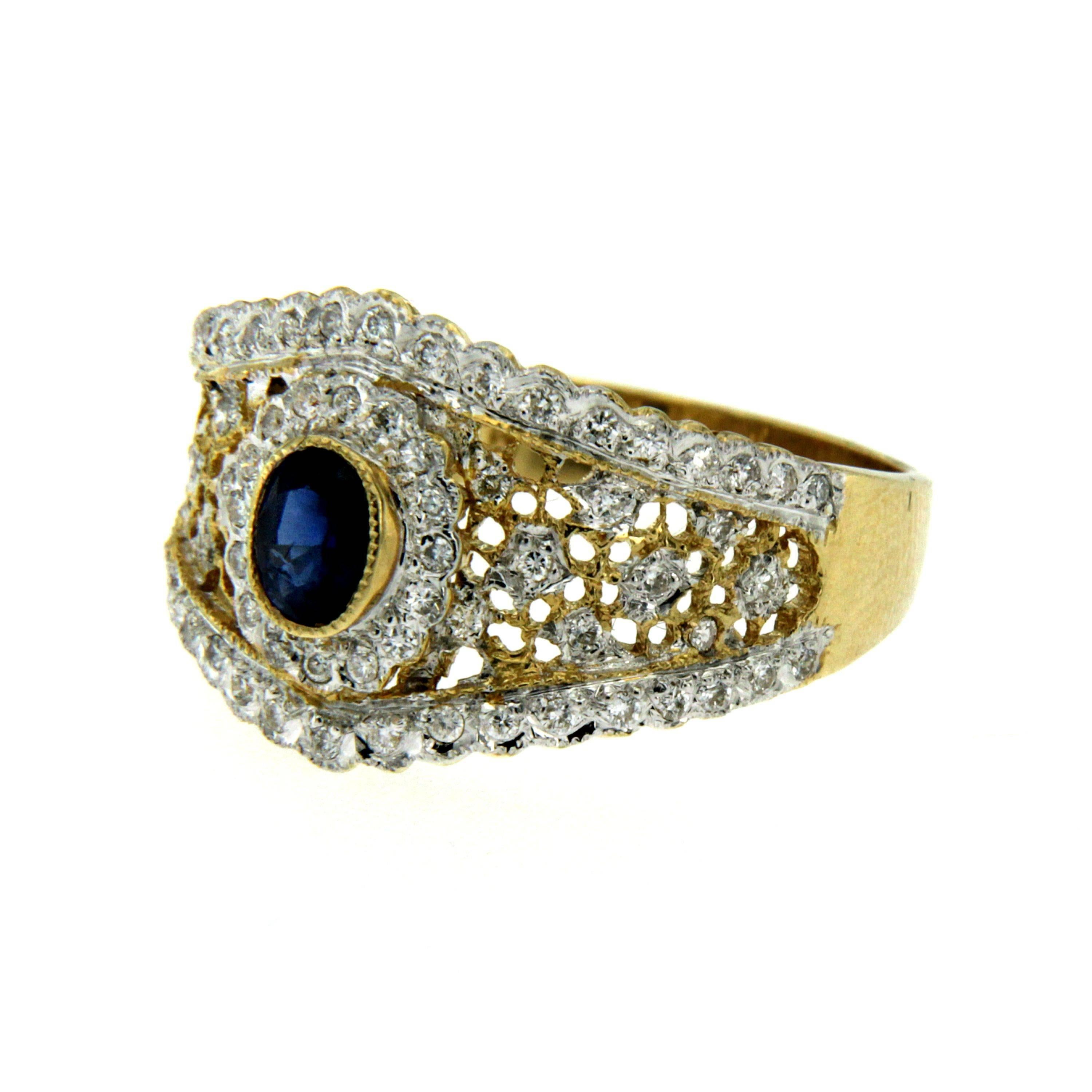 A gorgeous cocktail ring handmade in 18k yellow Gold showcasing a Natural Sapphire in the center weighing approx. 0.30 carat and surrounded by 0,80 carat of round brilliant-cut diamonds graded G color. Circa 1950

CONDITION: Pre-owned - Excellent