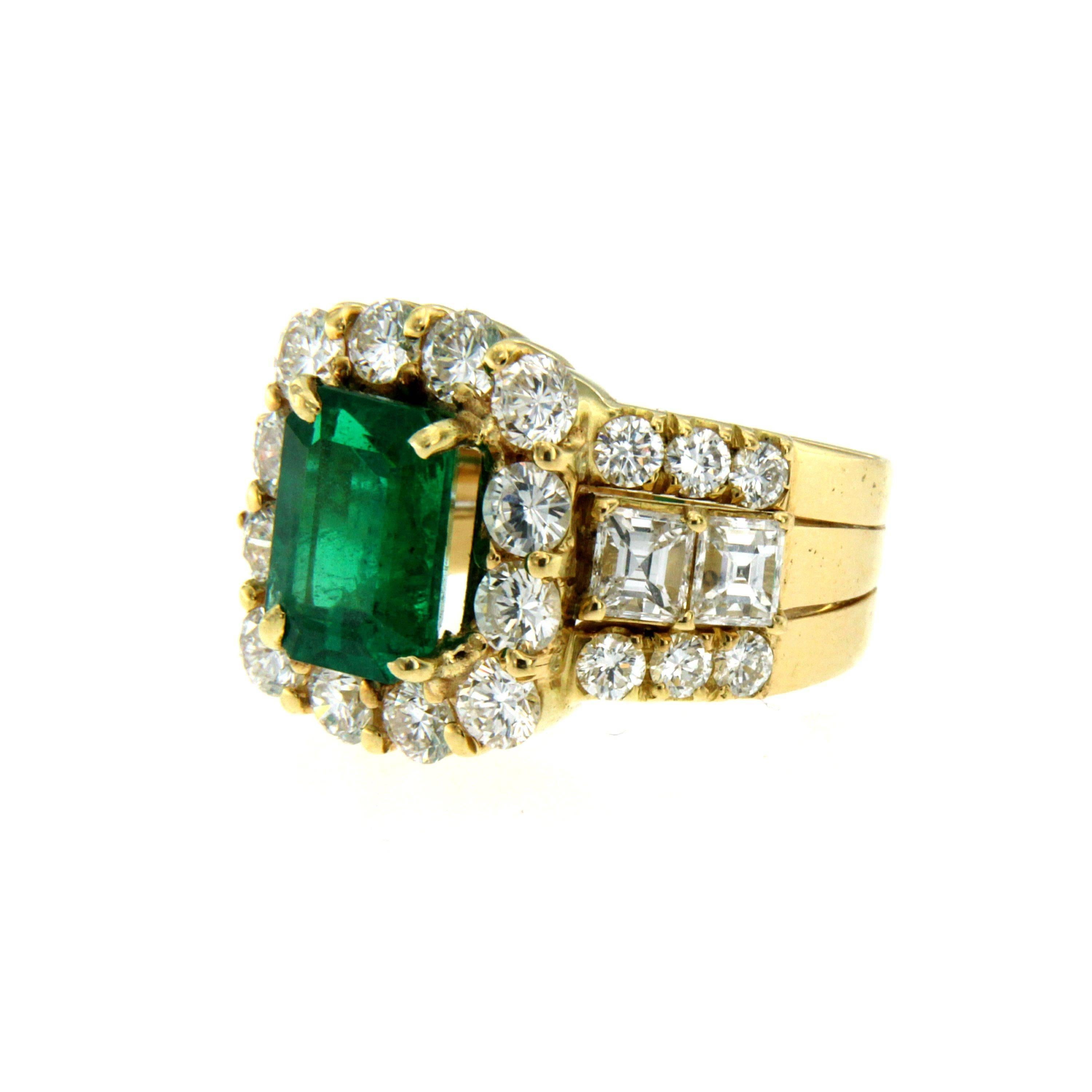 Emerald and Diamonds cocktail ring, handmade in 18k yellow gold.

An important 18k yellow gold mount showcasing an exceptional emerald-cut Emerald weighing approx. 2.80 carats, framed by 24 large, fine quality, round brilliant-cut diamonds and two