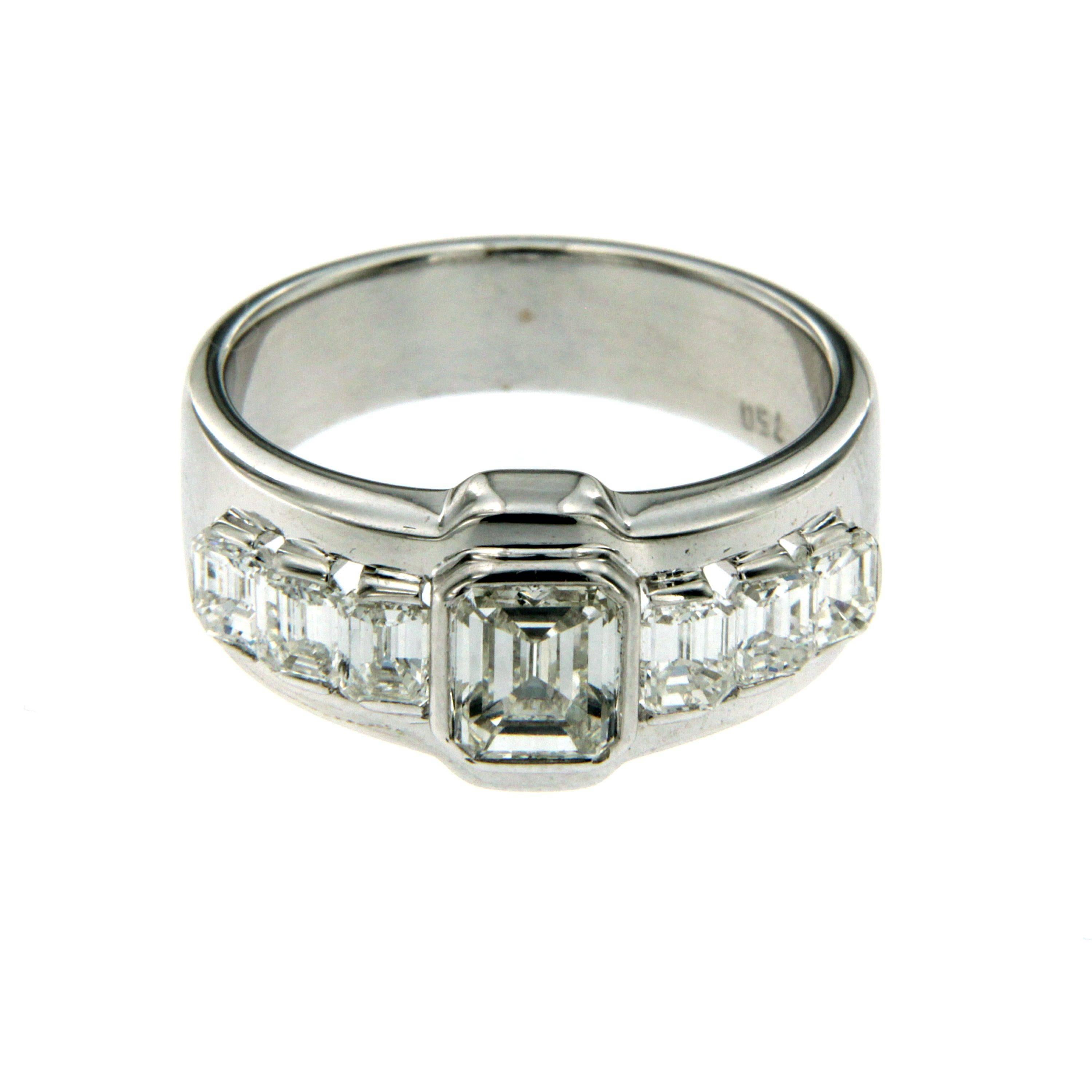 An exquisite engagement ring set in 18k white Gold featuring a 0.90 ct  diamond flanked on each side by 1.00 cts diamonds. 
All diamonds are square Emerald-cut  D color IF clarity.
This ring is from our own production.

CONDITION: Brand New
METAL:
