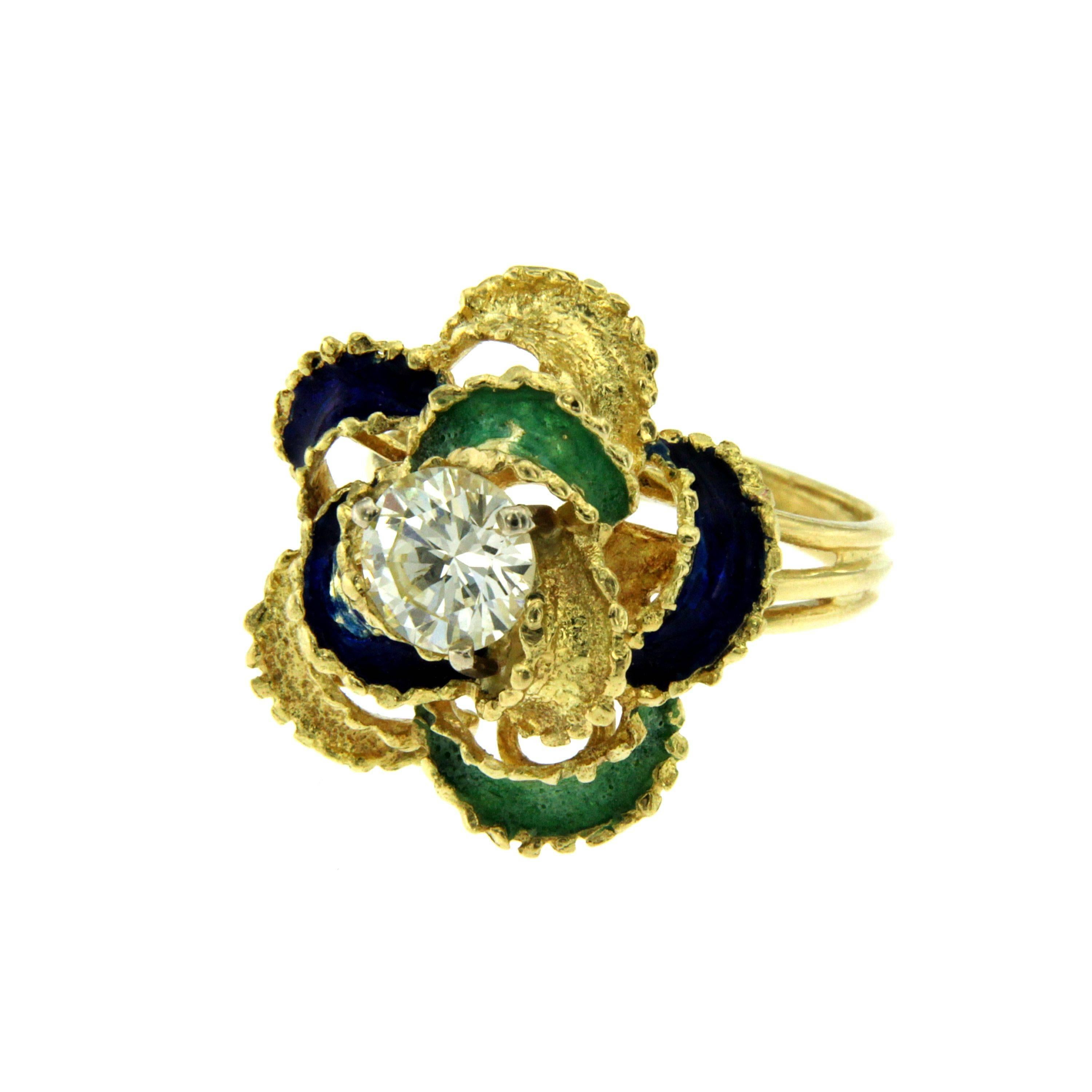 Flower ring hand-made in 18k yellow gold. 
The center of the flower is set with a round brilliant cut diamond weighing 1.30 carat H-I color Vs clarity. Gold leaves have been enamelled in blue and green. Circa 1950

CONDITION: Pre-owned - Excellent