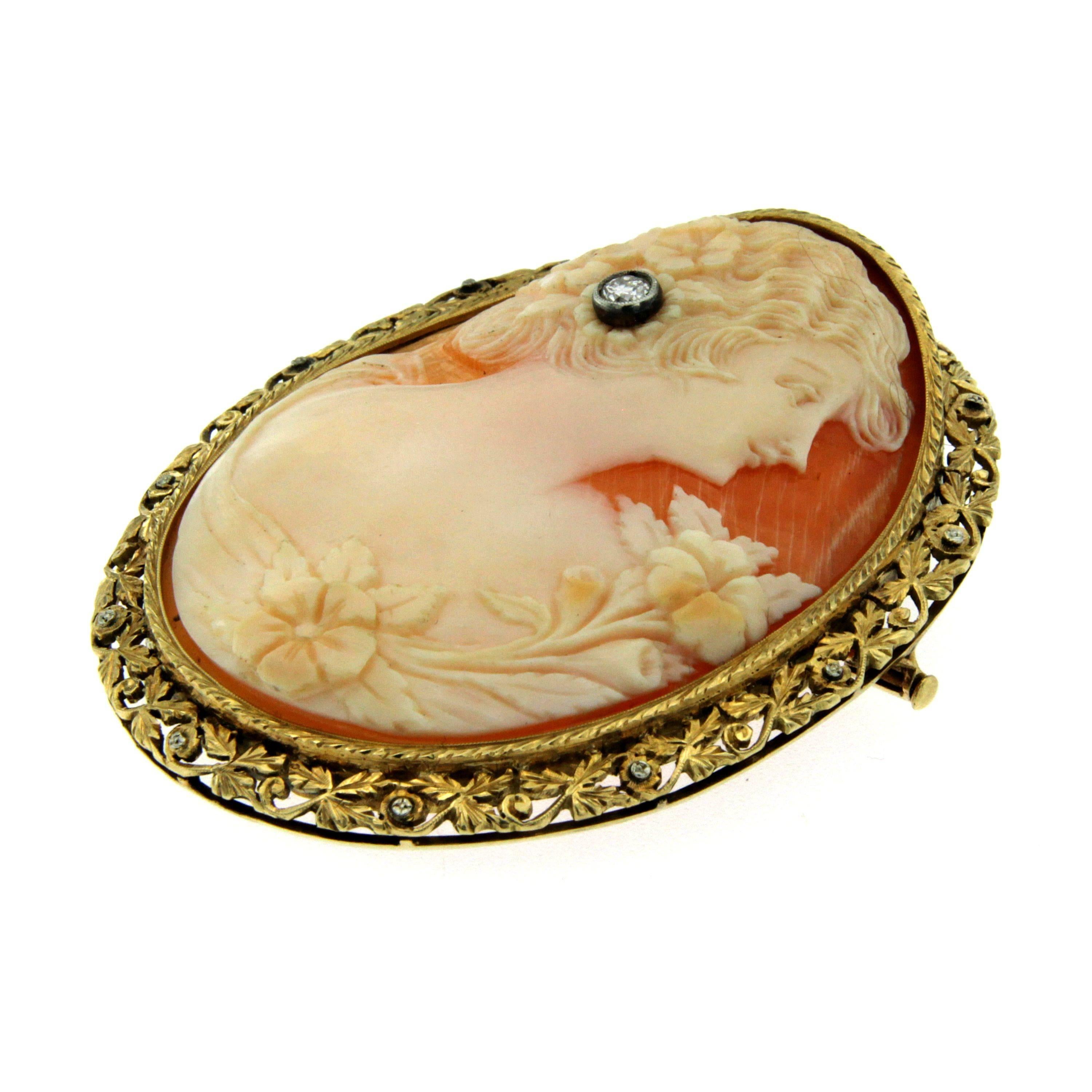 Antique Victorian shell and diamond cameo brooch decorated with a classical female head in profile adorned with a 0.20 carat old cut diamond surrounded by an elaborately engraved 14k gold frame.

CONDITION: Pre-owned
METAL: 14k Gold 
DESIGN ERA: